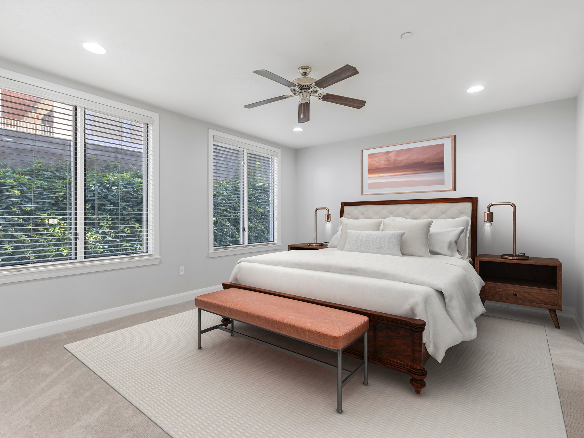 Spacious room featuring two large windows with blinds, recessed lighting, and a ceiling fan
