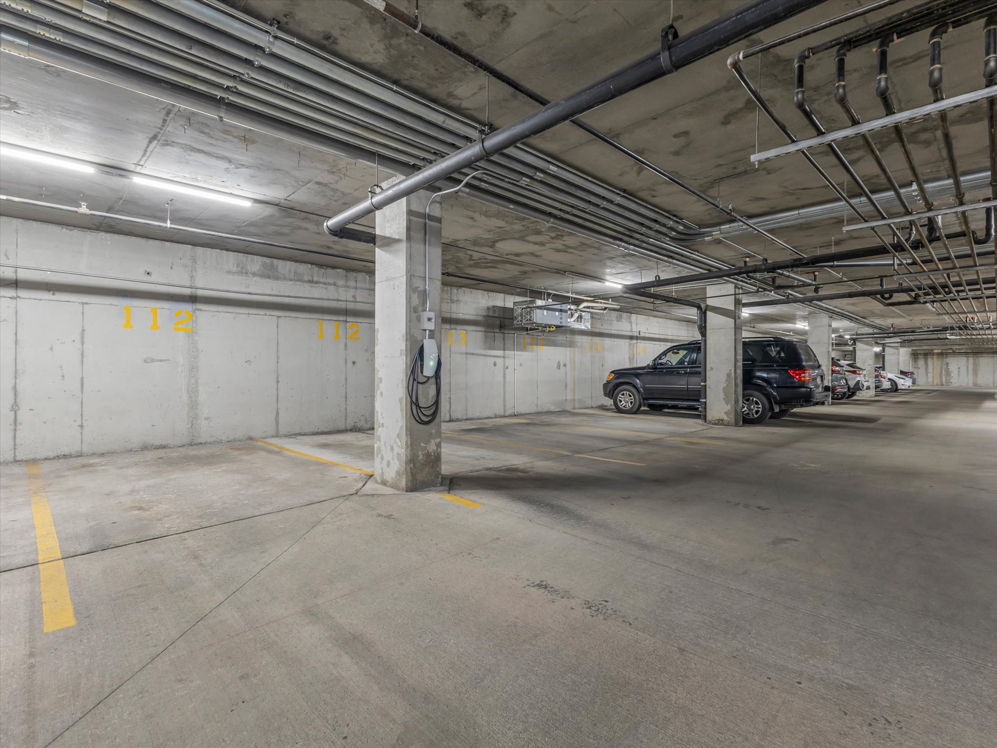 Concrete parking garage with dedicated parking space and electric vehicle charging station