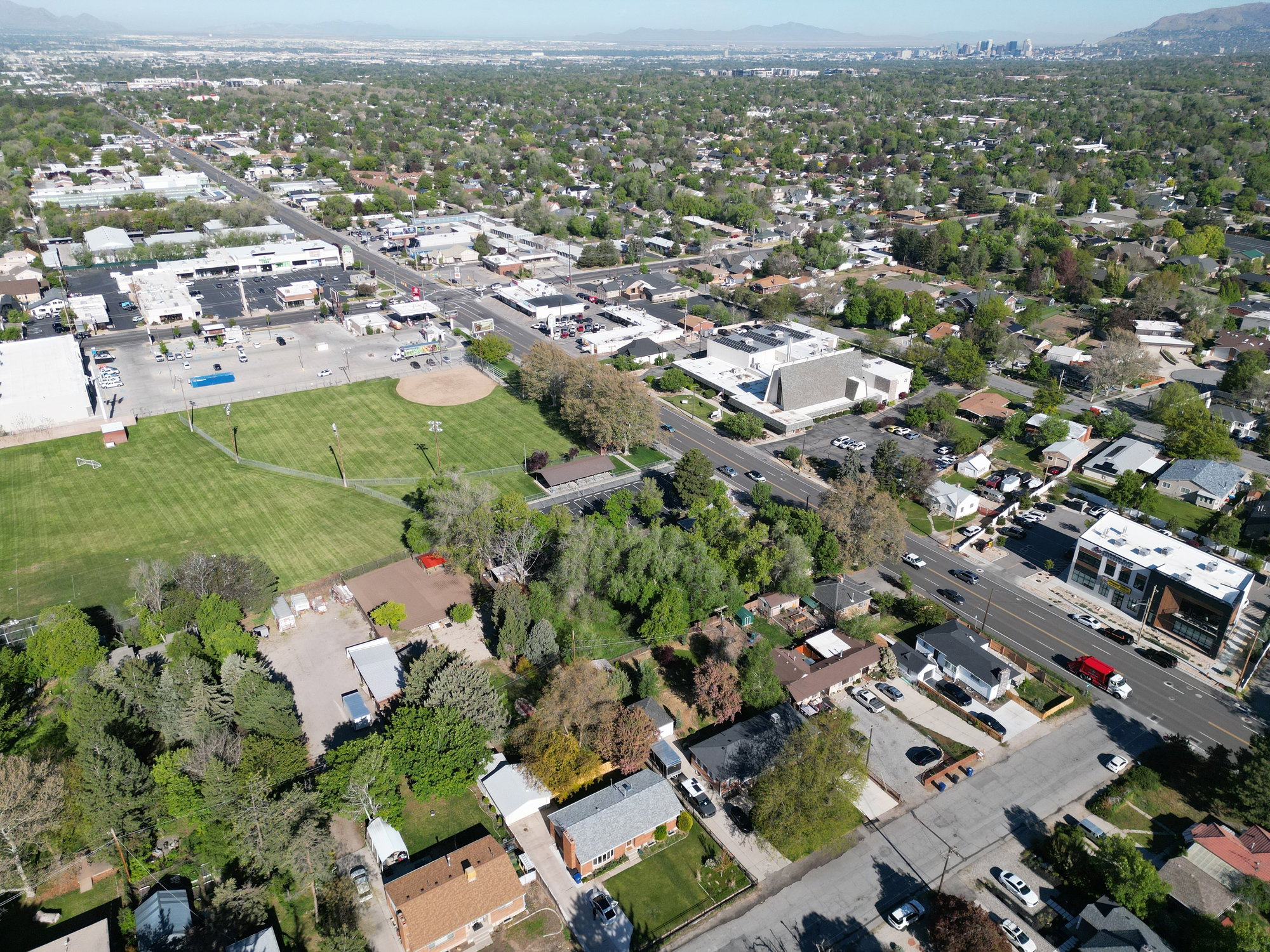 Aerial perspective showcasing established residential areas alongside commercial properties and expansive green spaces