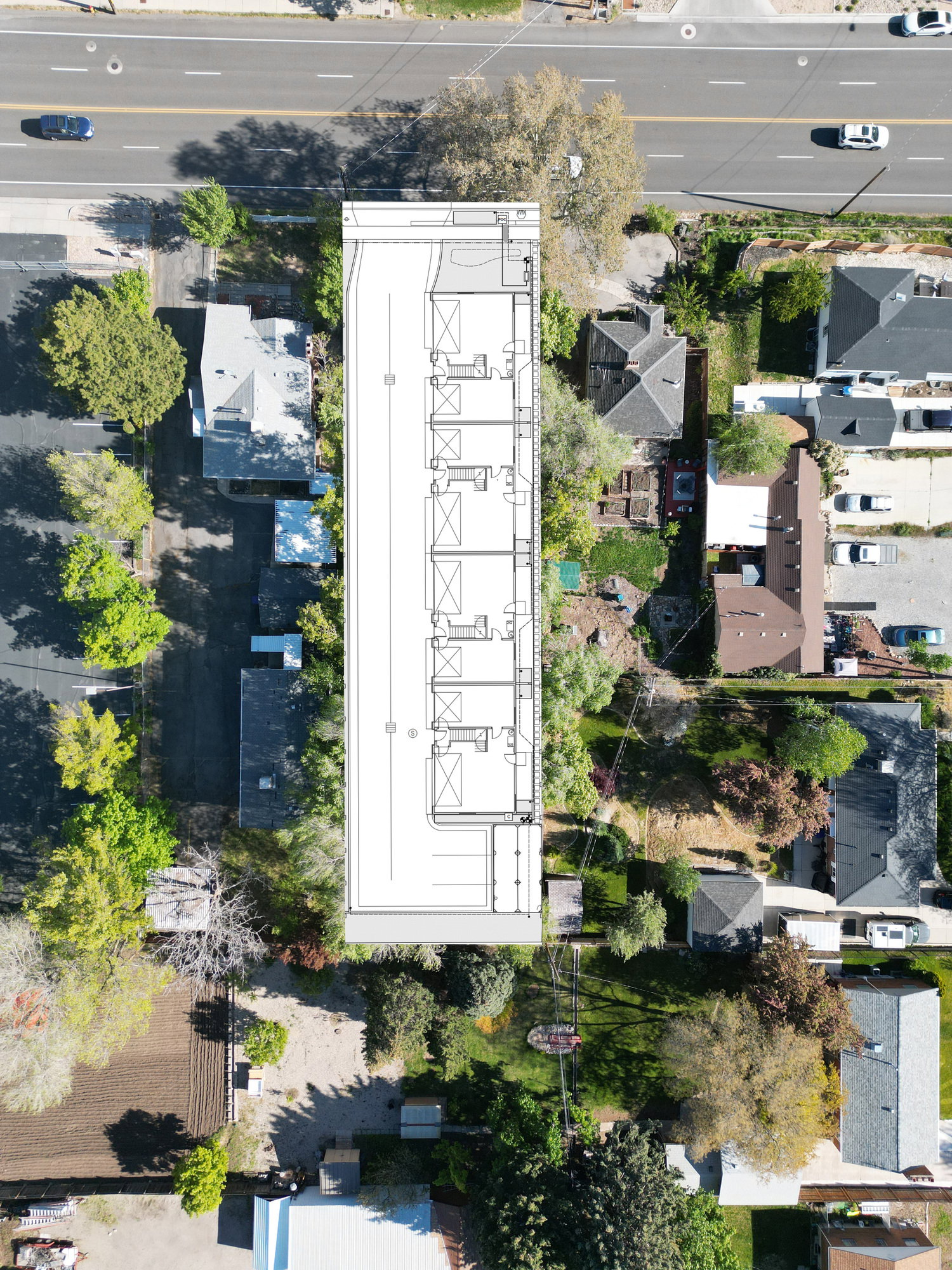 Aerial overview highlighting a long, rectangular building plan superimposed onto an existing urban landscape