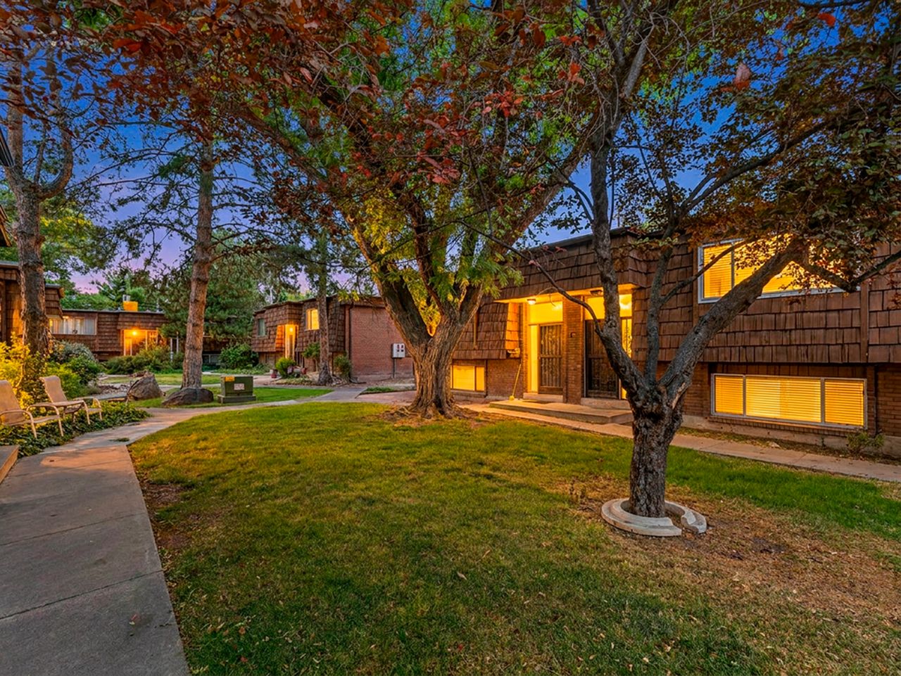 Exterior features include brick and cedar-shake siding, multiple windows, and a prominent entry