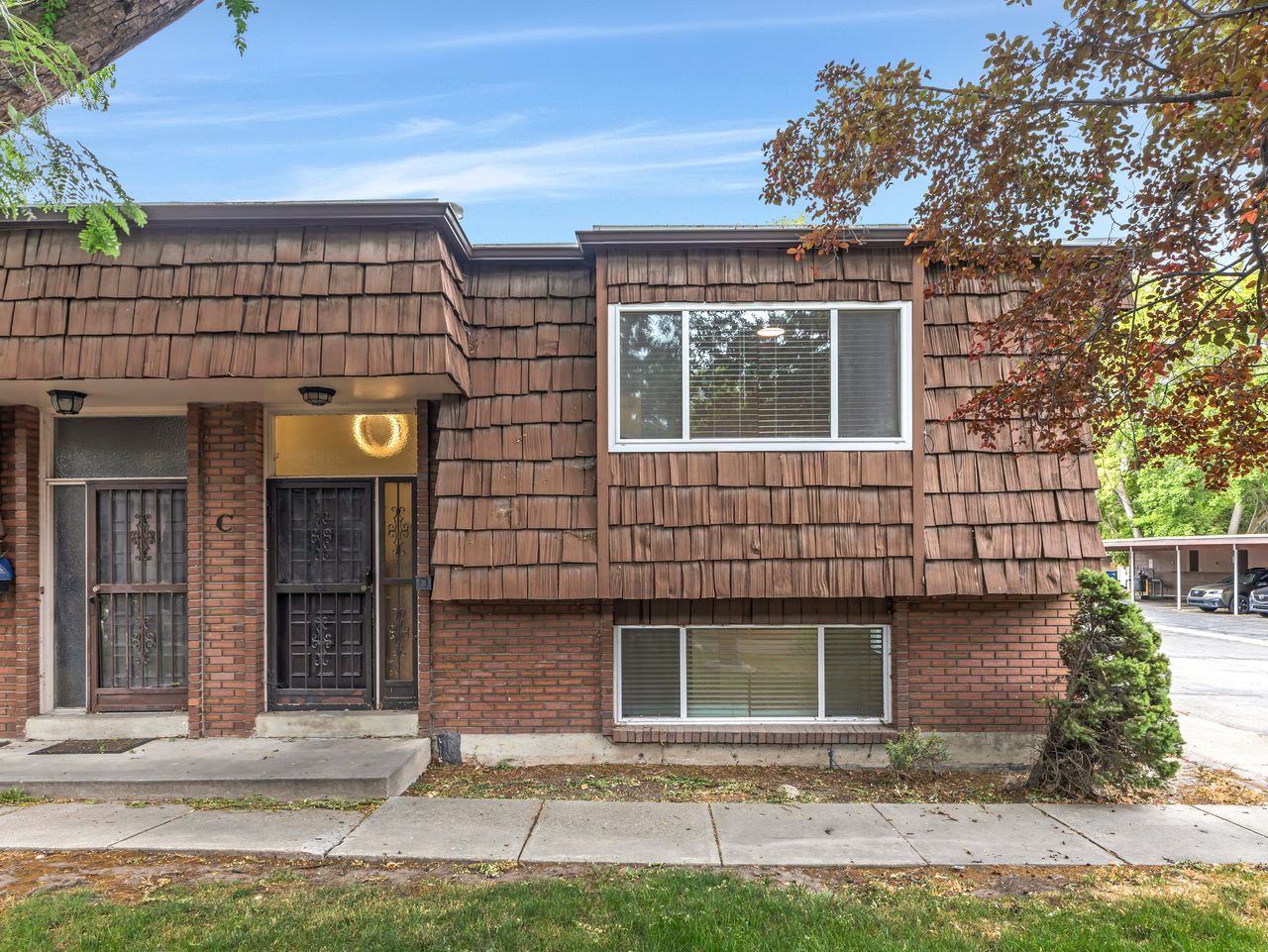 Brown shingle siding exterior with brick accents