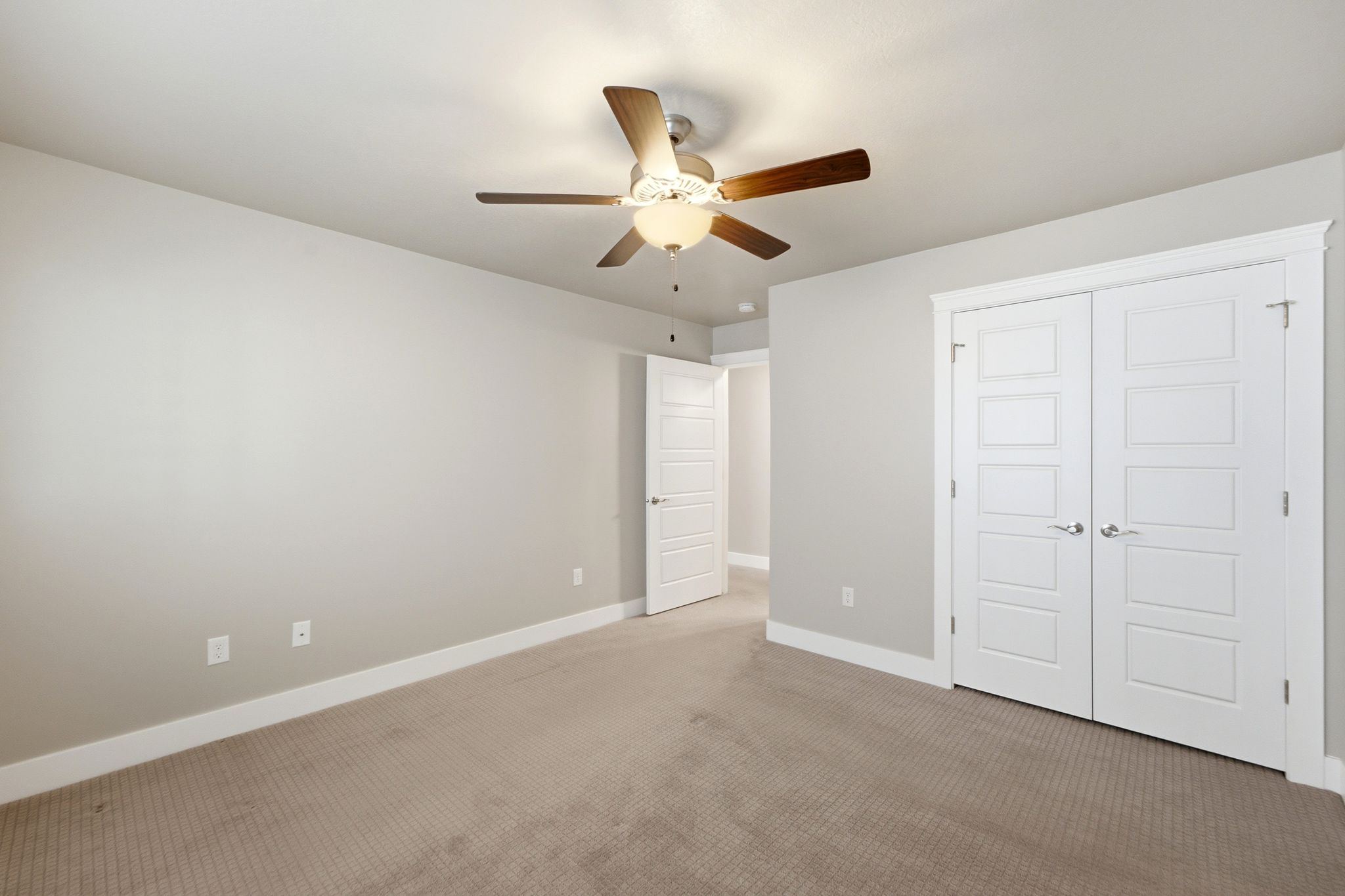 Neutral-toned carpet flooring and light gray wall paint create a versatile interior