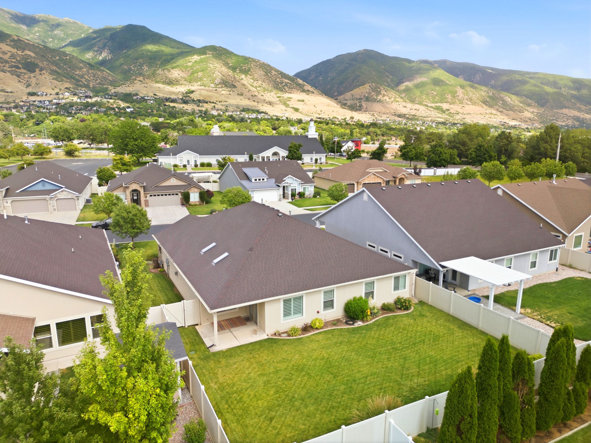 Residential property featuring a spacious backyard with a manicured lawn, a covered patio, and privacy fencing