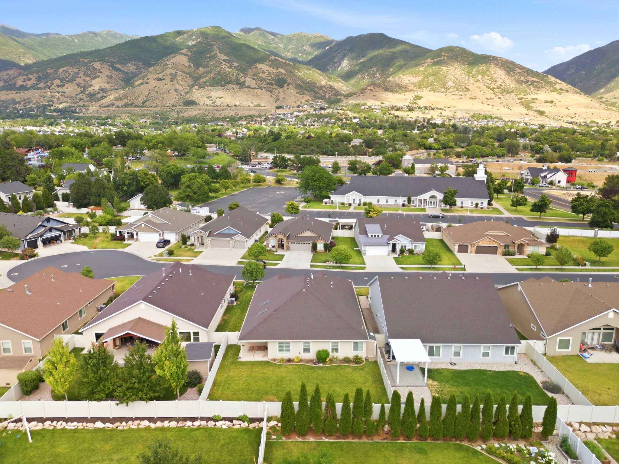 Residential neighborhood featuring mature landscaping and mountain scenery