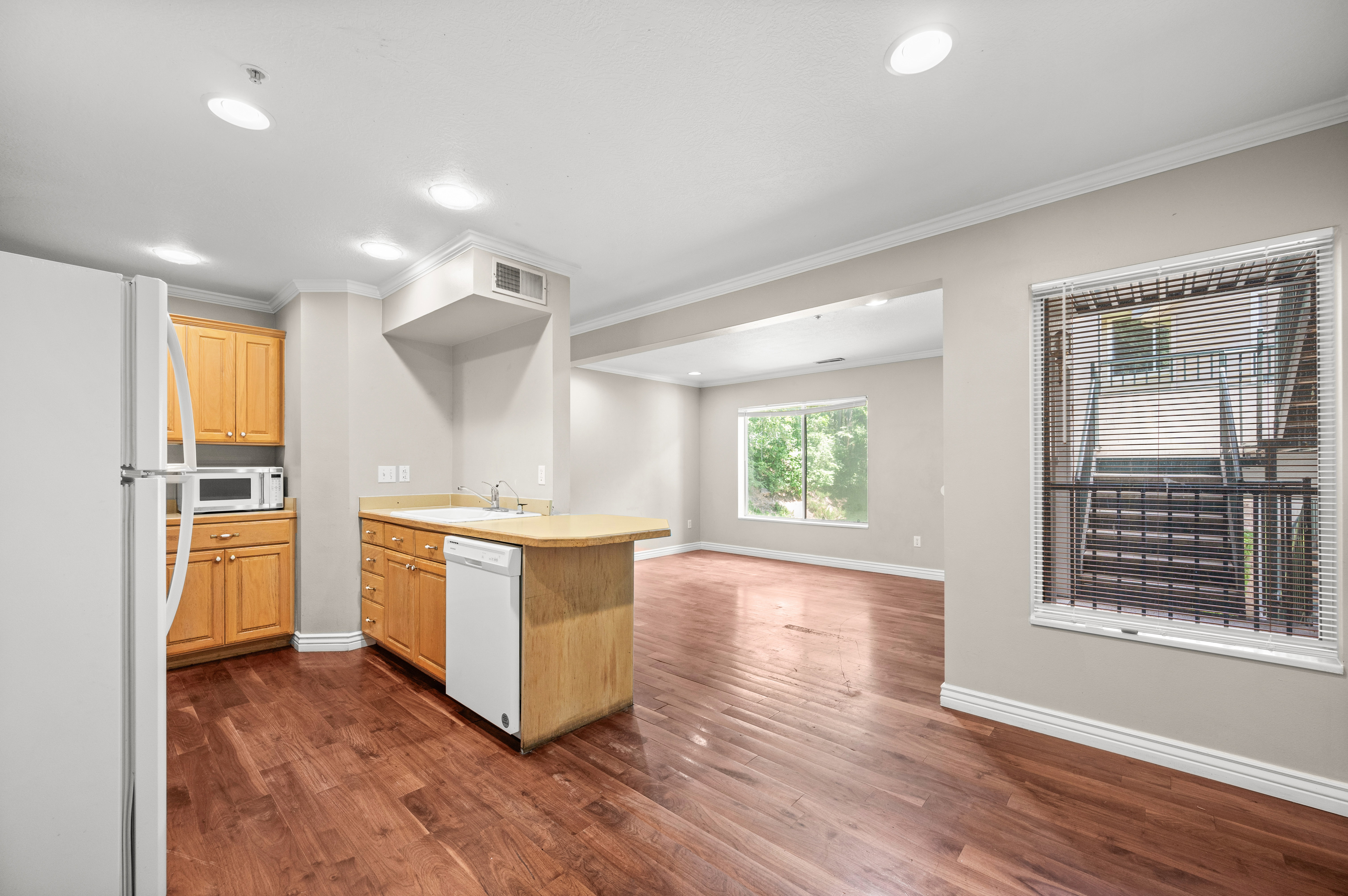 Open-concept living area featuring rich wood-finish flooring