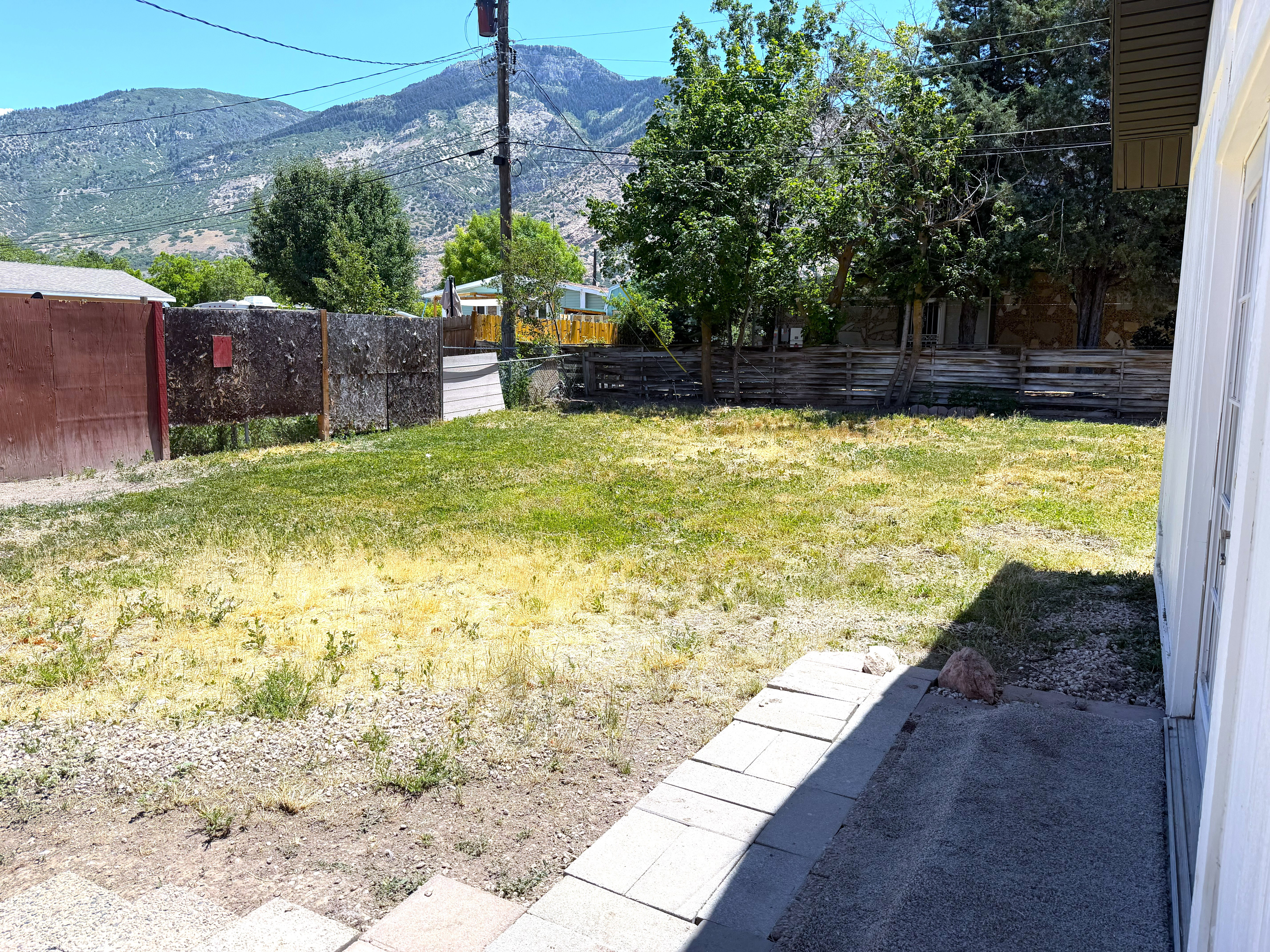 Expansive outdoor space featuring a partial gravel ground covering and a section of green area