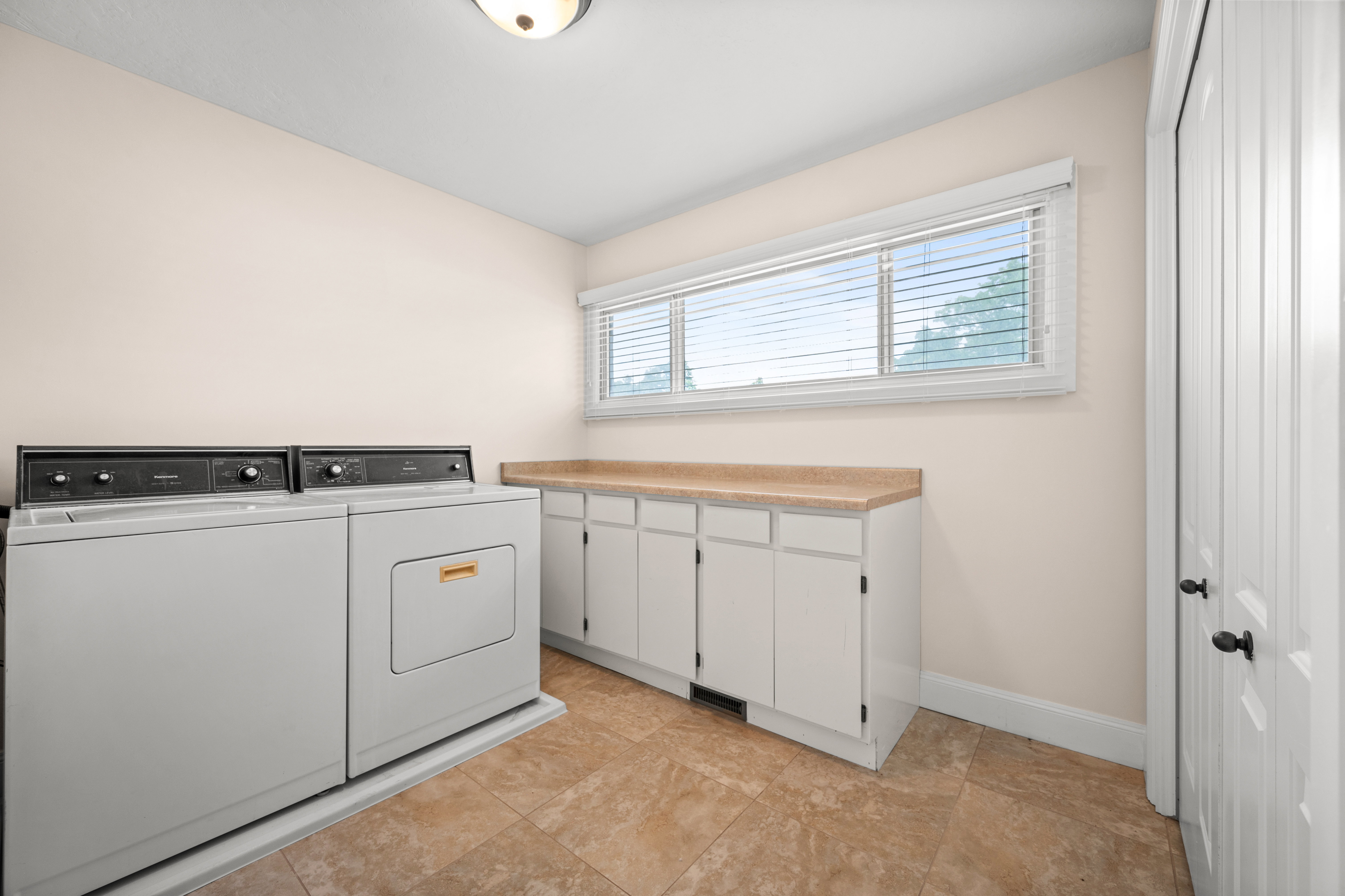 Designed with convenience in mind, this large laundry room offers plenty of storage to help keep your home organized and running smoothly.