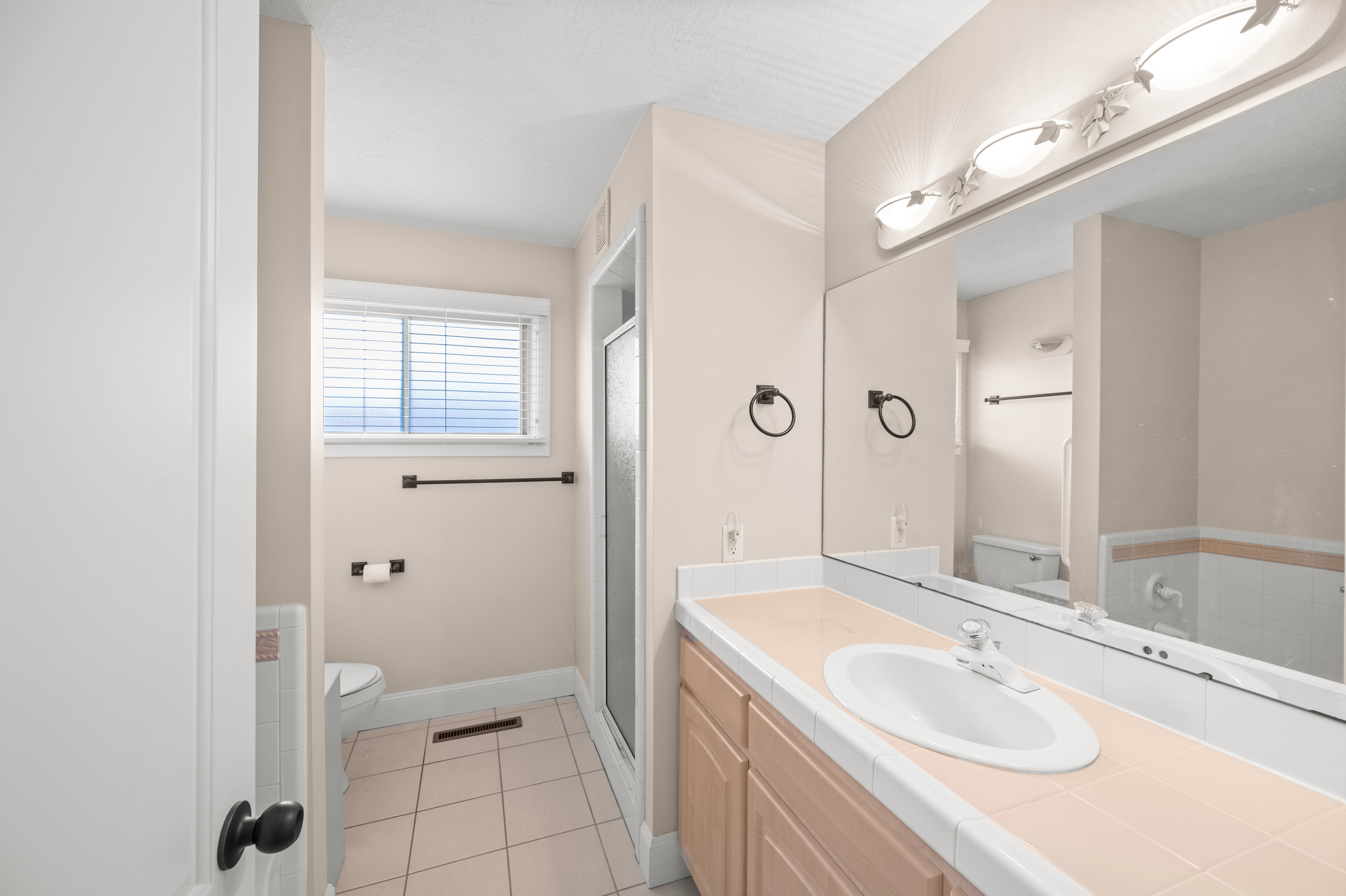 Escape to your own private retreat in this spacious bathroom, where a separate soaking tub and walk-in shower create the perfect balance of comfort, relaxation, and everyday luxury.