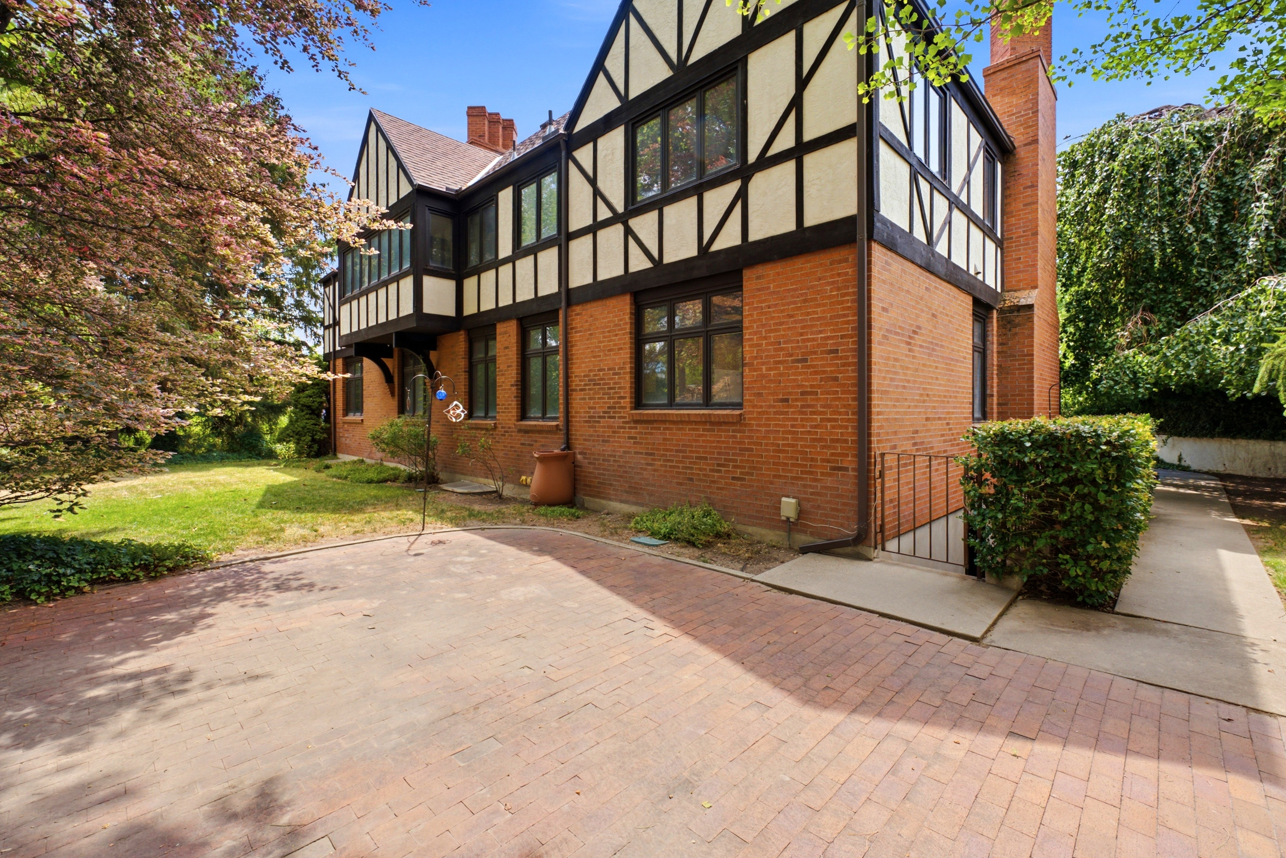 Tudor-style exterior featuring red brick and dark timber framing