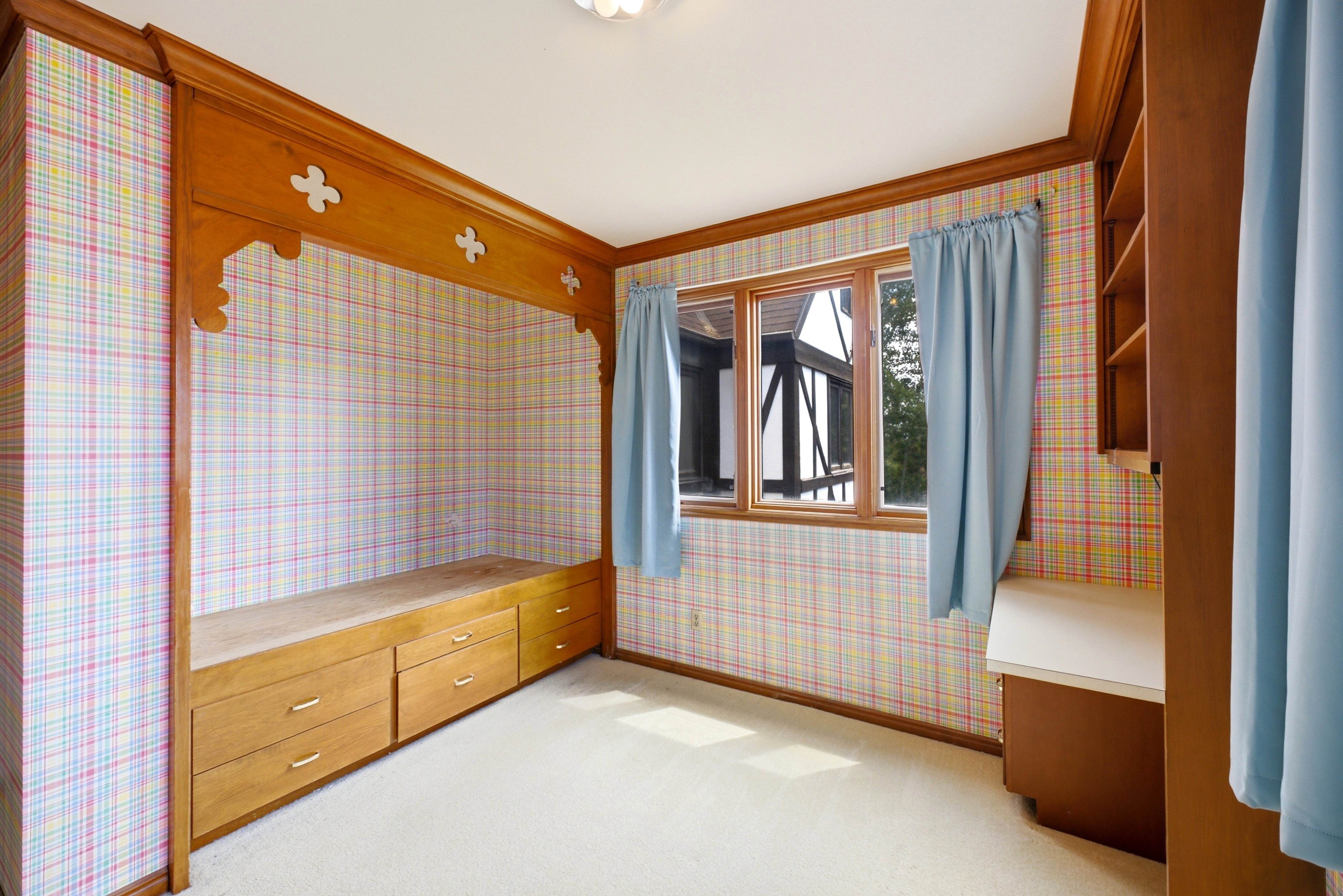 Built-in bed frame with carved wood detailing and integrated drawers