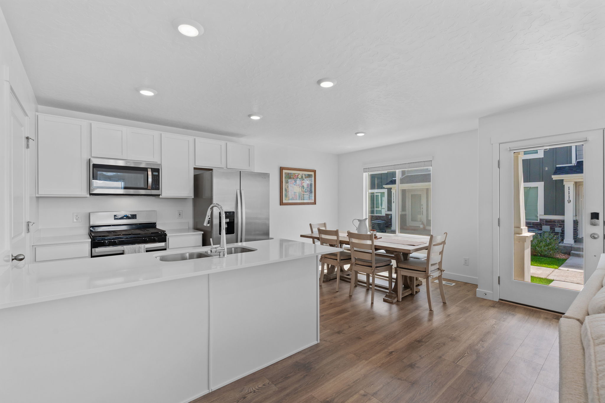 Kitchen. Stainless Steel Appliances. White Cabinets. Quartz tops. Gorgeous warm solid surface flooring. Large windows! Can lights. Beautiful white walls. Bright! Open Concept!