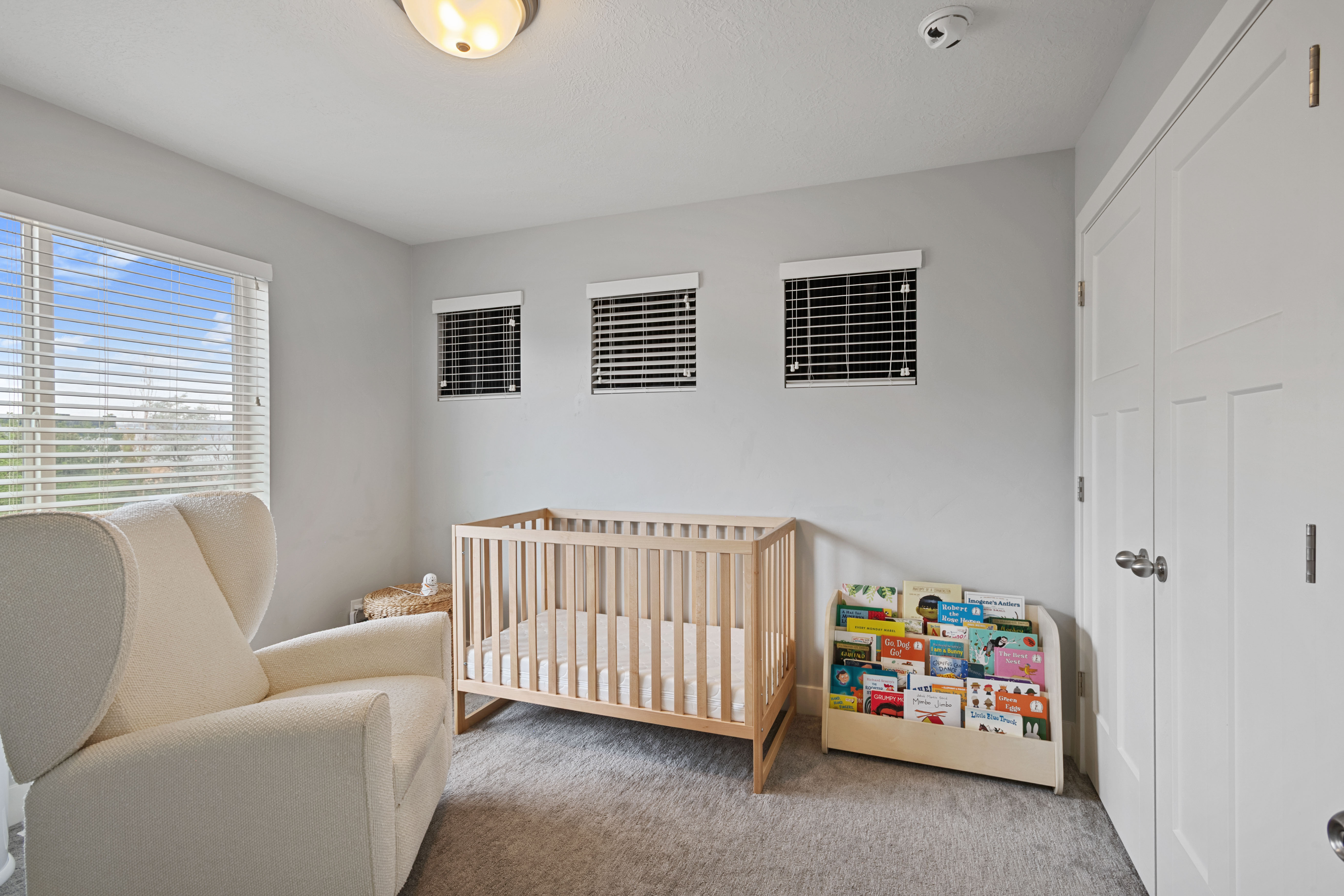 Light gray walls complement the neutral carpeting