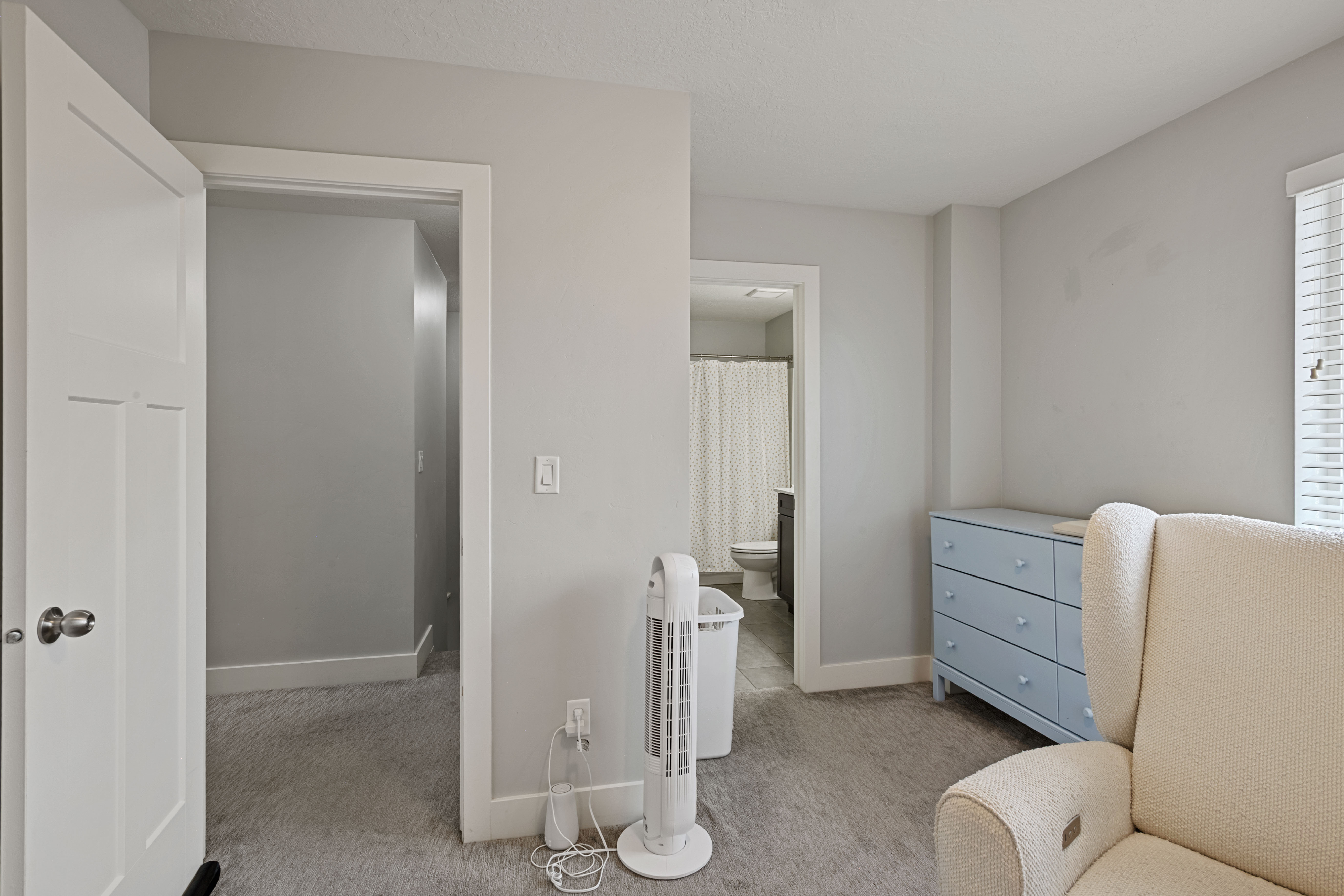 Carpeted interior space with light gray wall paint and white trim