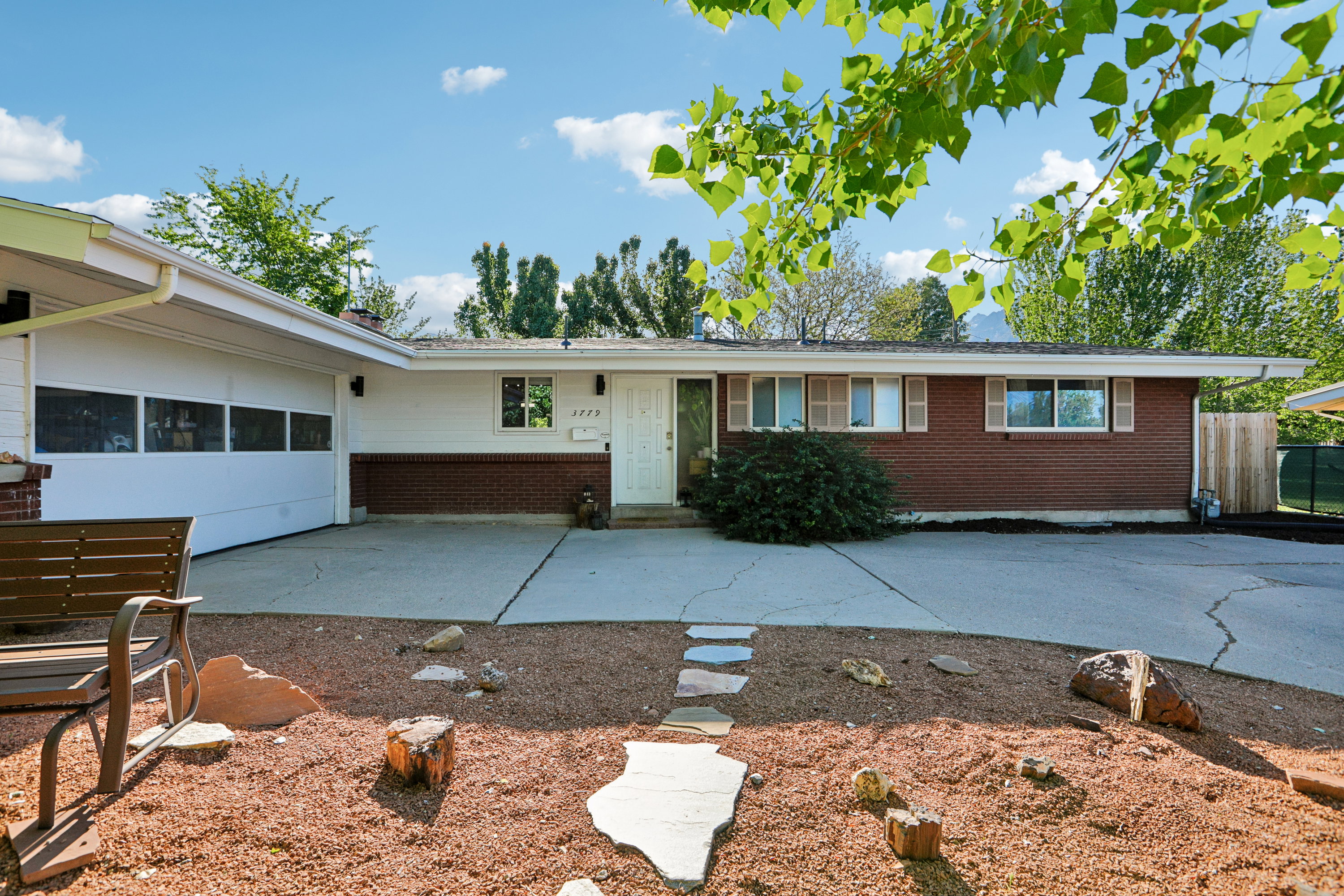 Brick and white siding exterior with an attached two-car garage