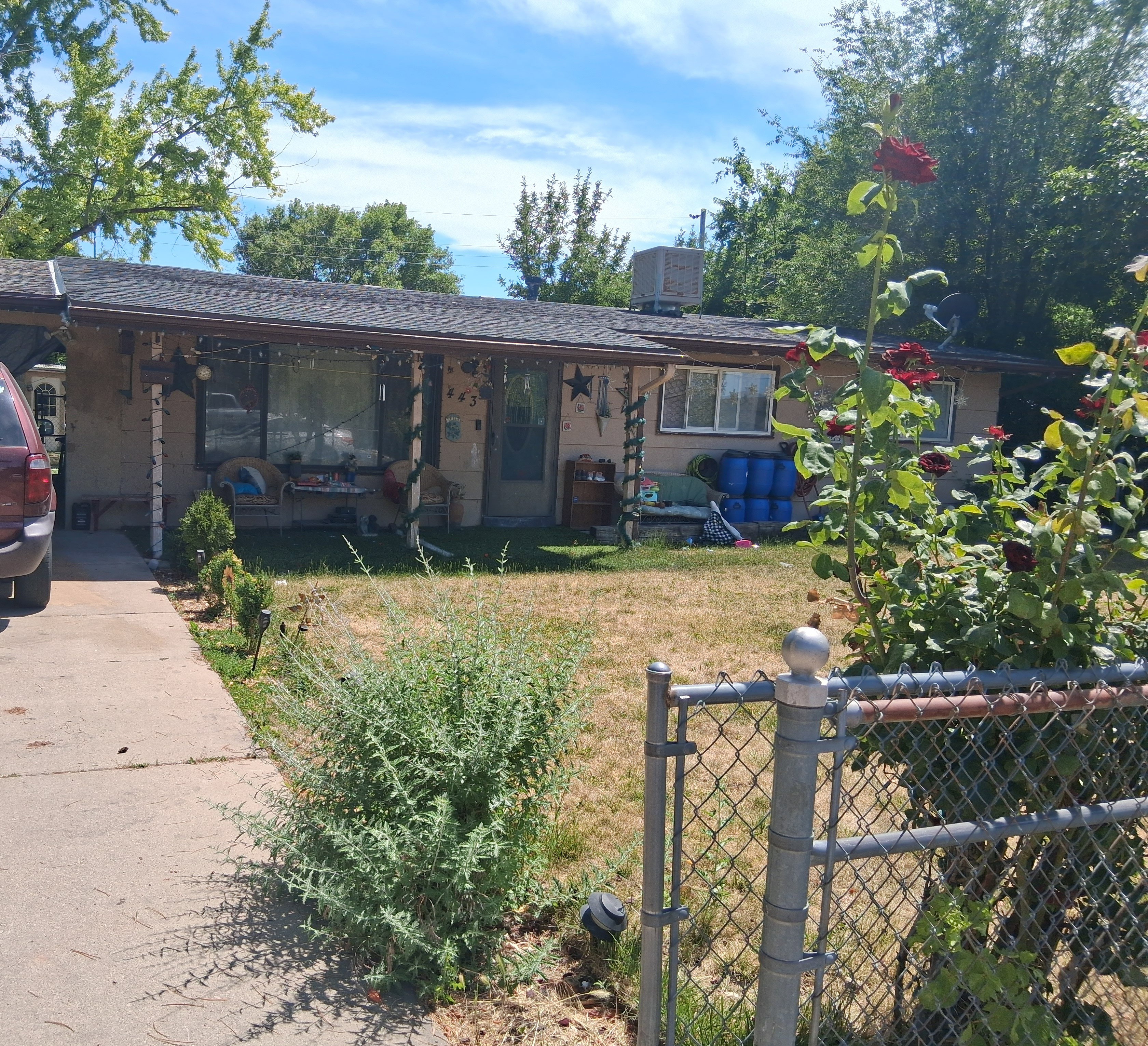 Single-story residence featuring a covered front porch and a paved driveway
