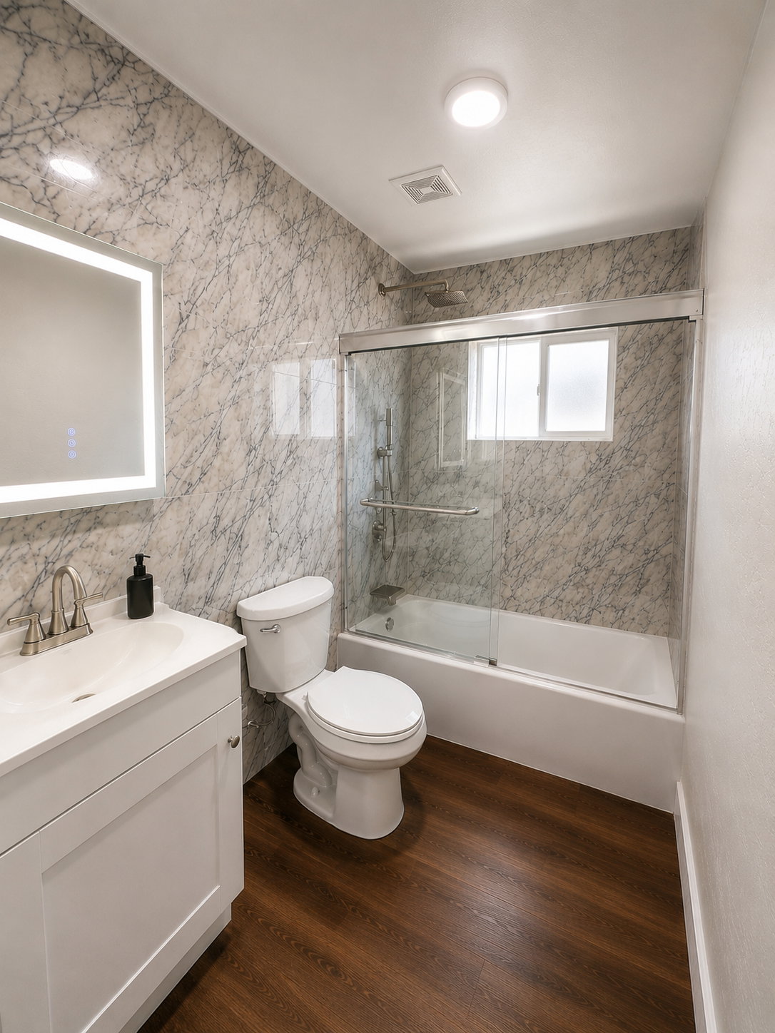 Bathroom with wood-finish flooring and a white vanity with an integrated sink