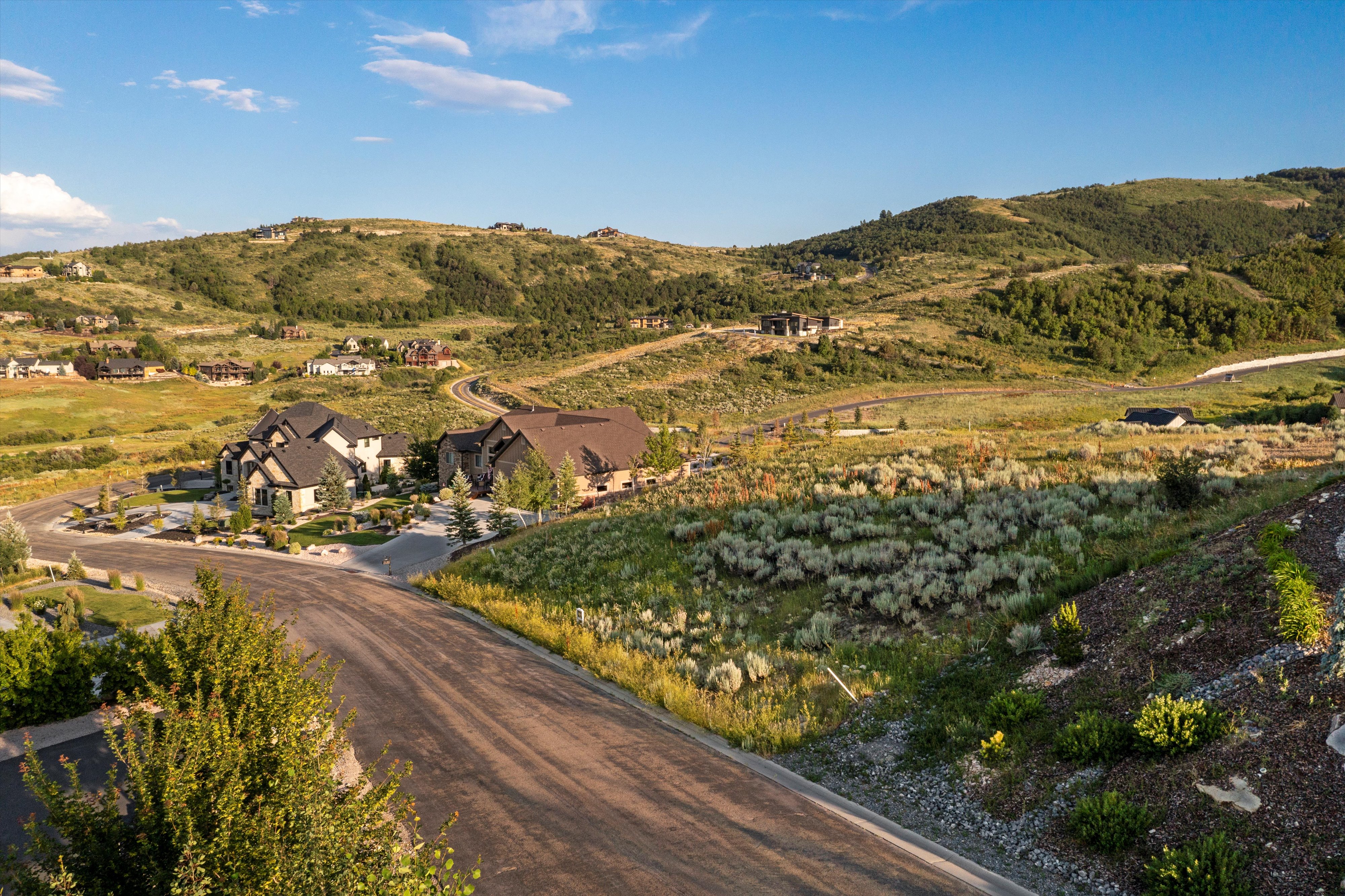 Expansive hillside community featuring multiple modern residences with varied architectural designs