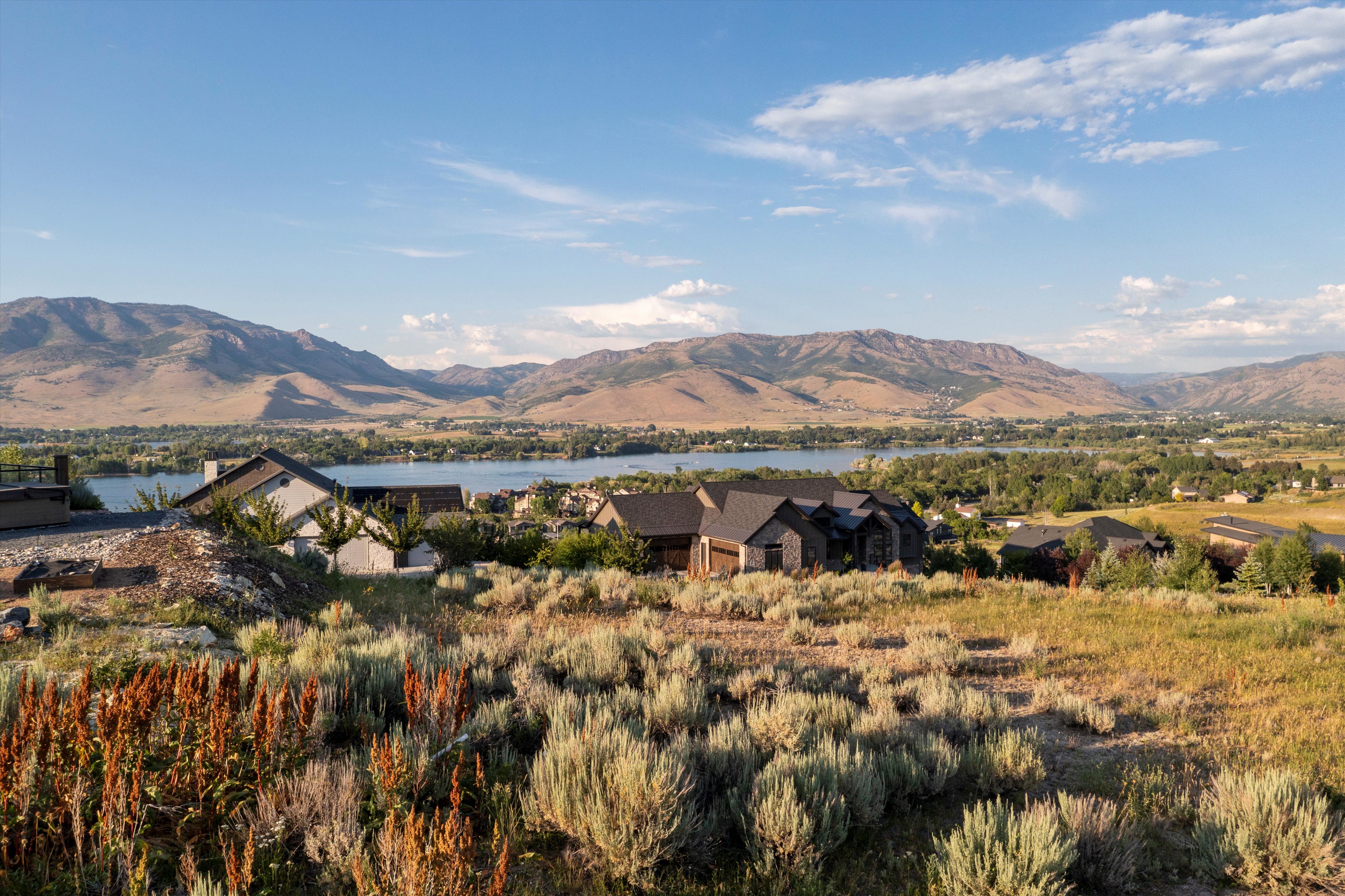 Expansive landscape featuring distant mountains and a large body of water