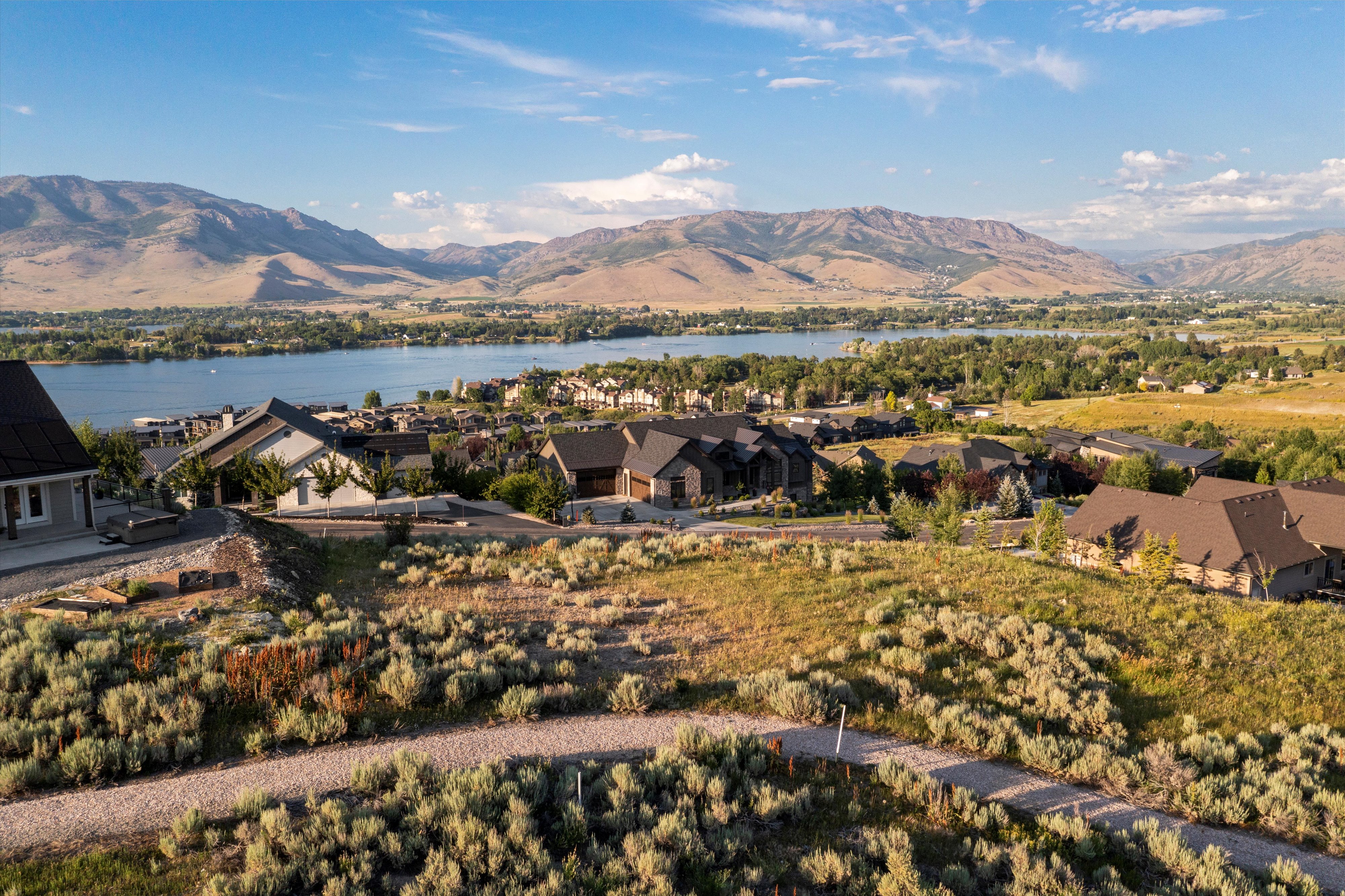 Expansive property offering a panoramic landscape with a lake and mountains