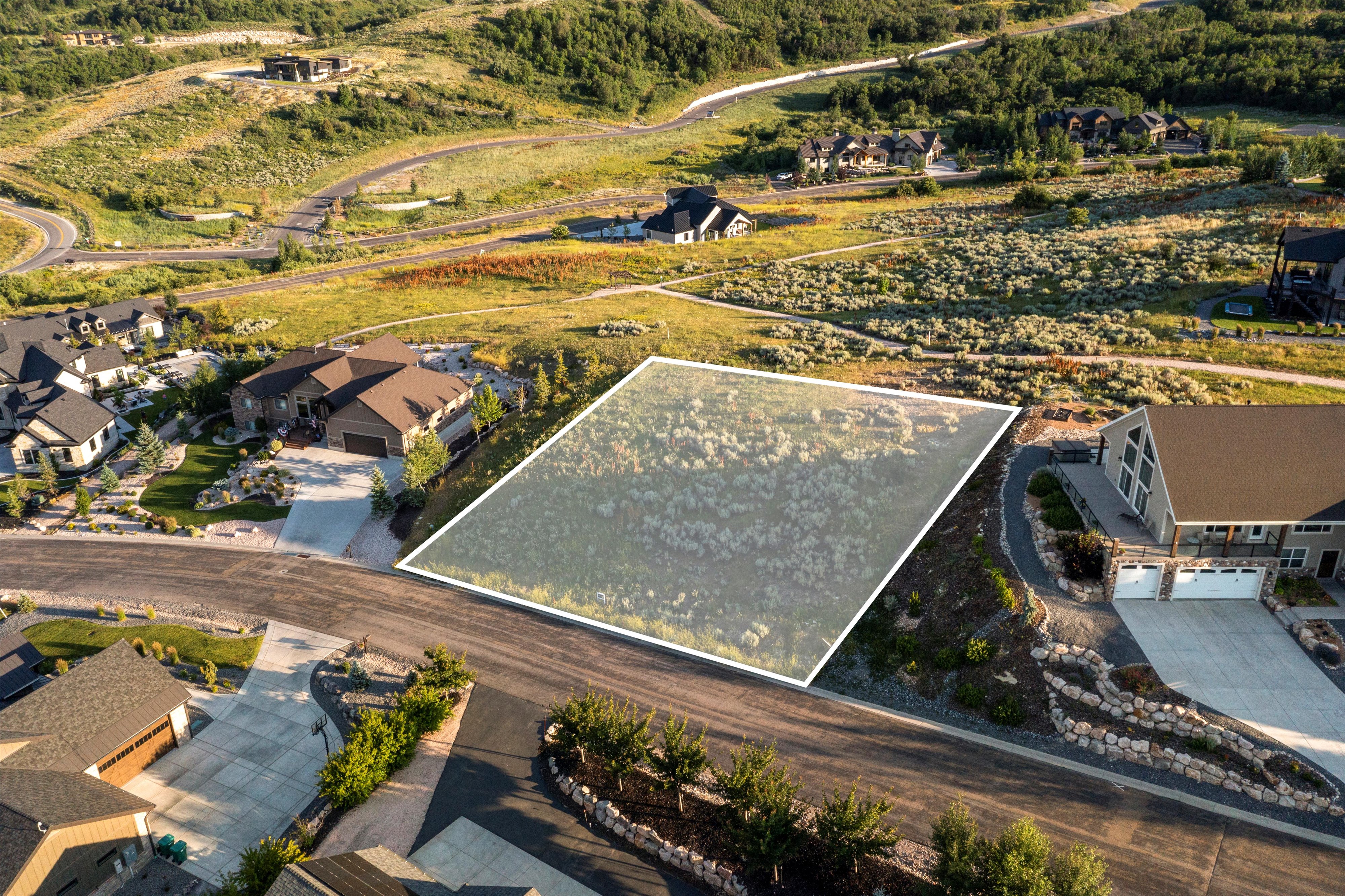 Expansive undeveloped land parcel featuring natural ground cover and a sloped terrain