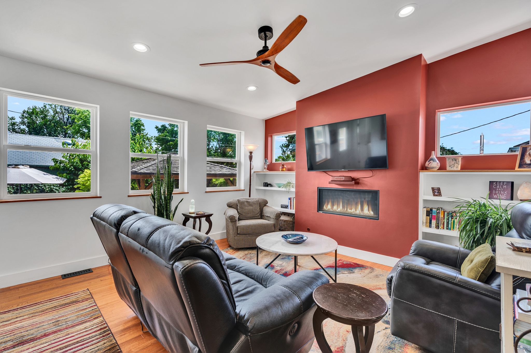 Living area featuring wood-finish flooring, recessed lighting, and a modern ceiling fan