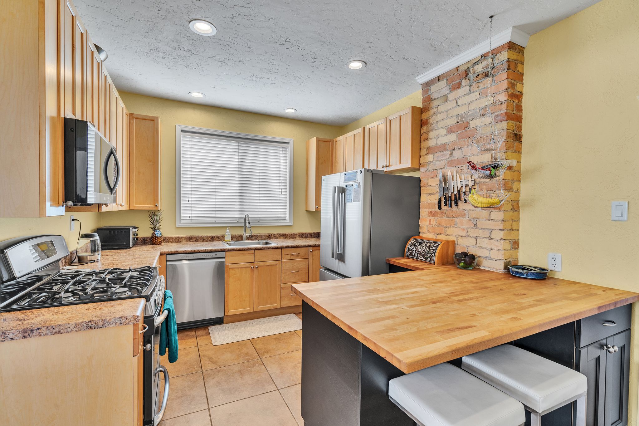 Kitchen featuring a stainless steel range, built-in microwave, and a stainless steel dishwasher