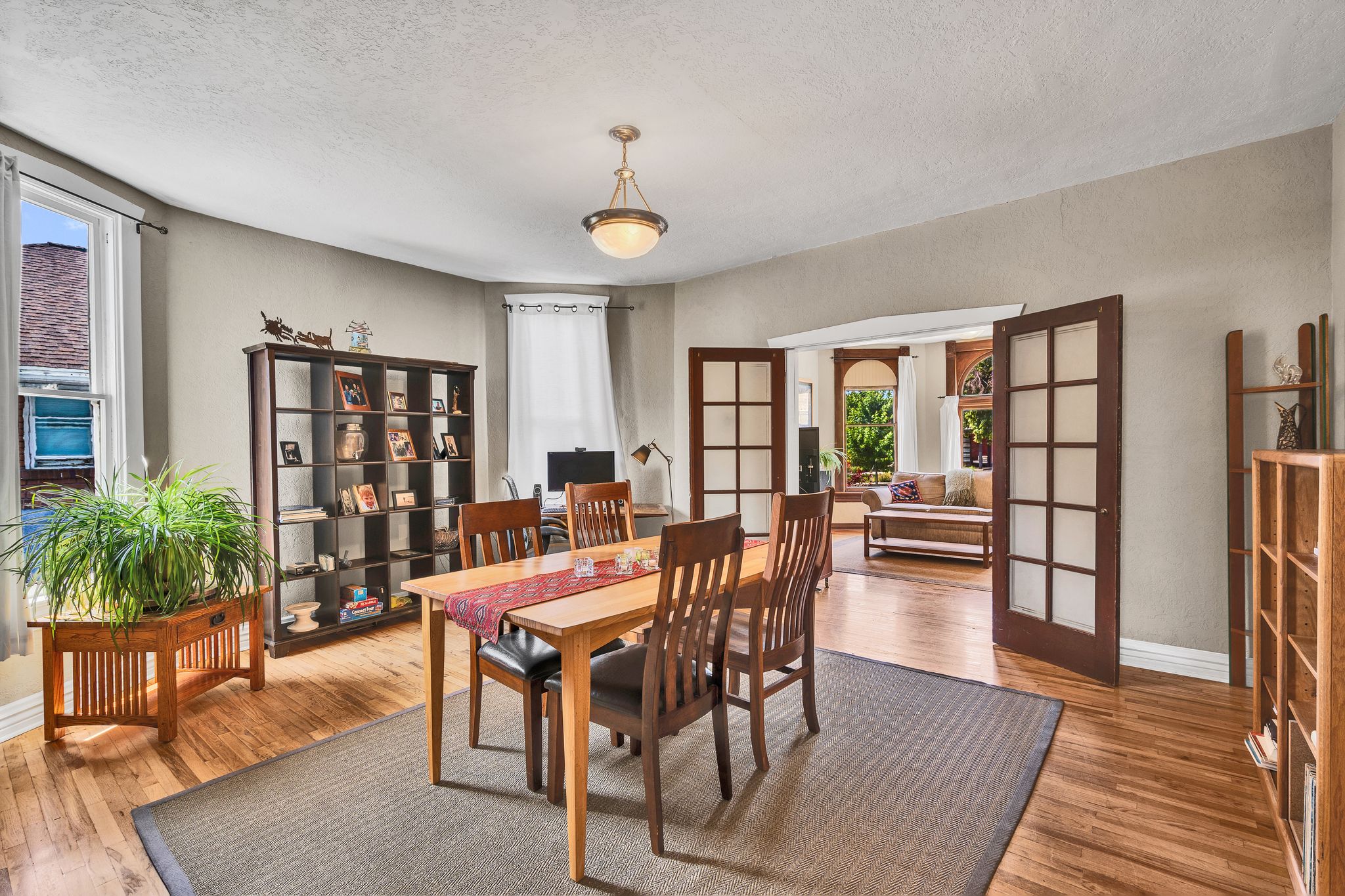 Spacious dining room with hardwood floors, and a beautiful bay window.