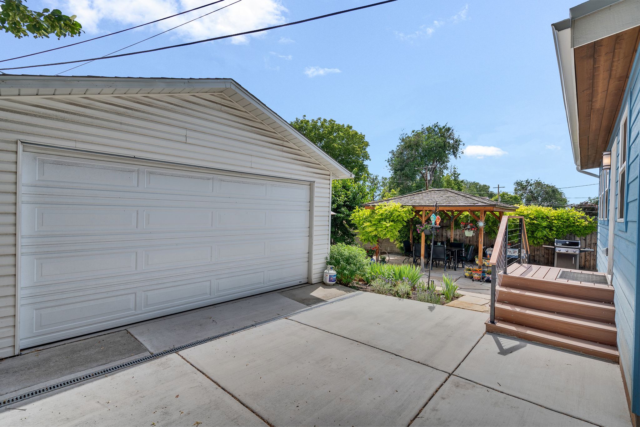 new concrete driveway leading to a two-car garage.