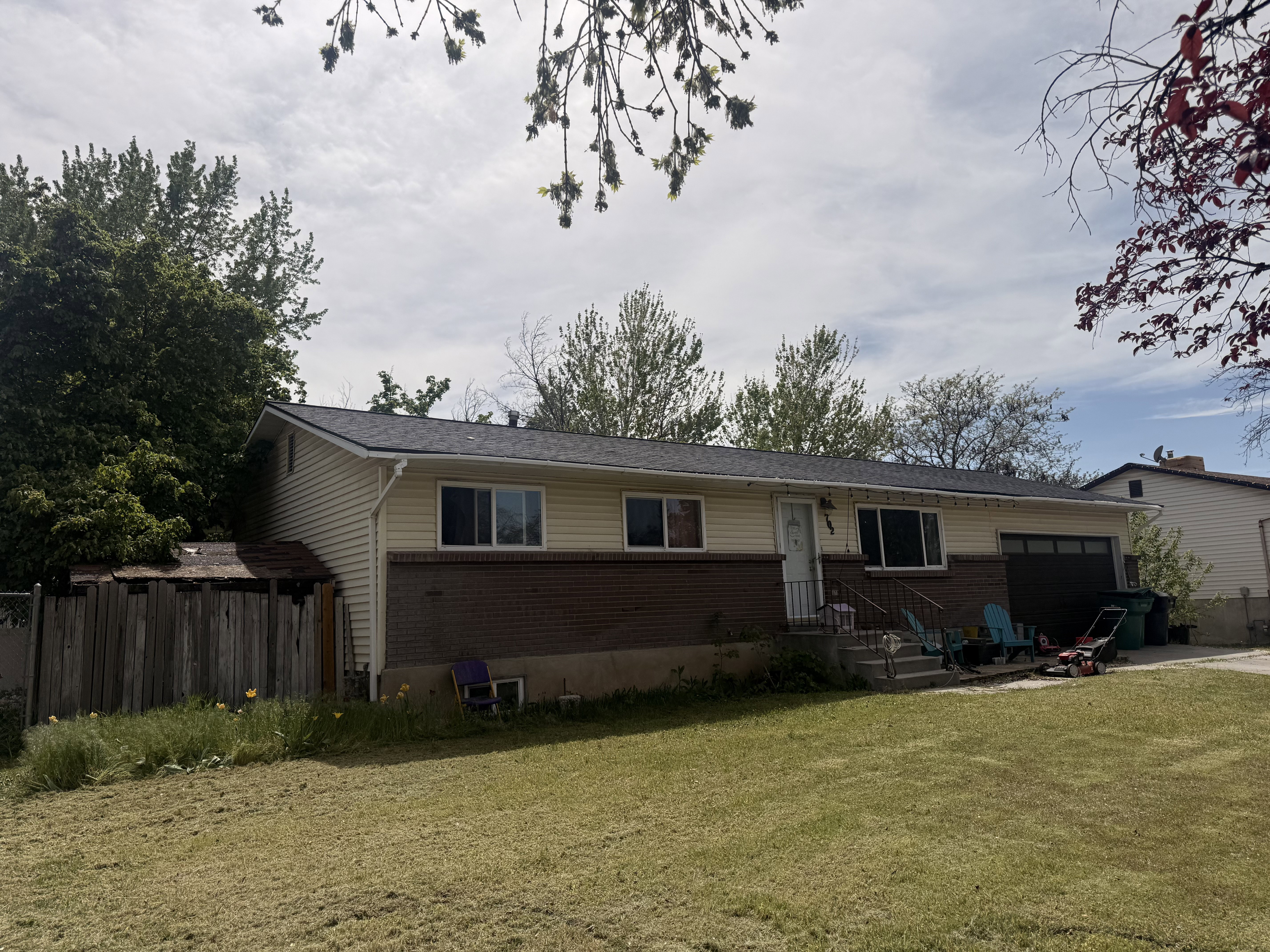 Single-story home featuring a combination of brick and horizontal siding, a dark shingle roof, and a front entry with handrails