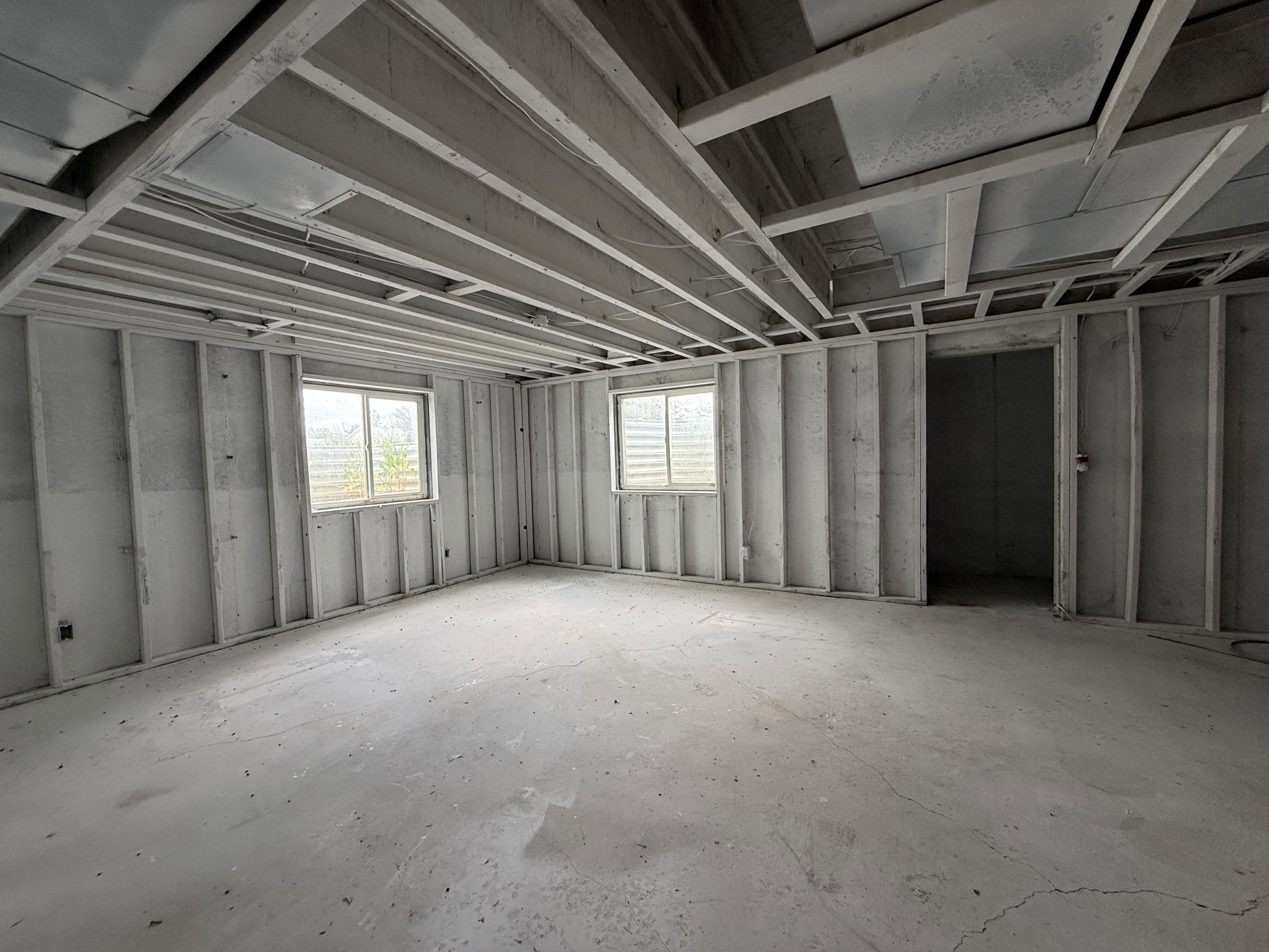 Unfinished room with exposed ceiling joists and wall studs