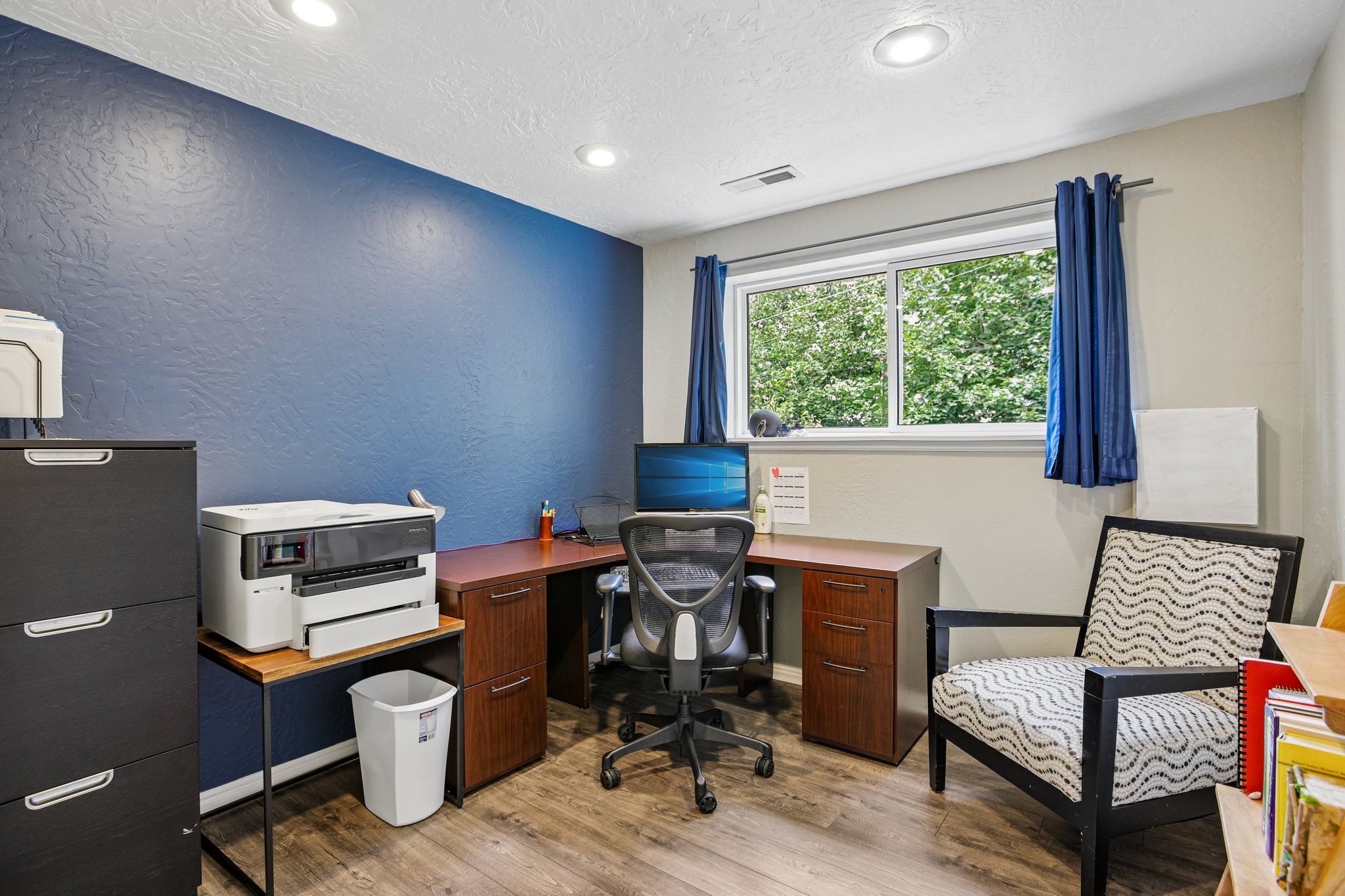 Versatile room featuring wood-finish flooring, recessed lighting, and a large window with white trim