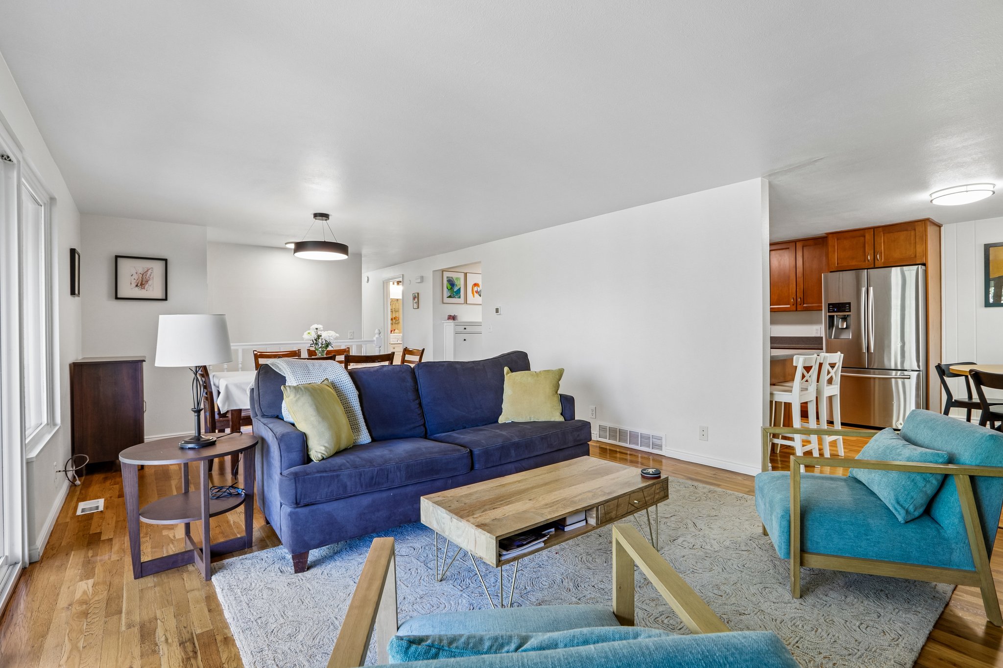 Open-concept living space featuring hardwood flooring and white walls