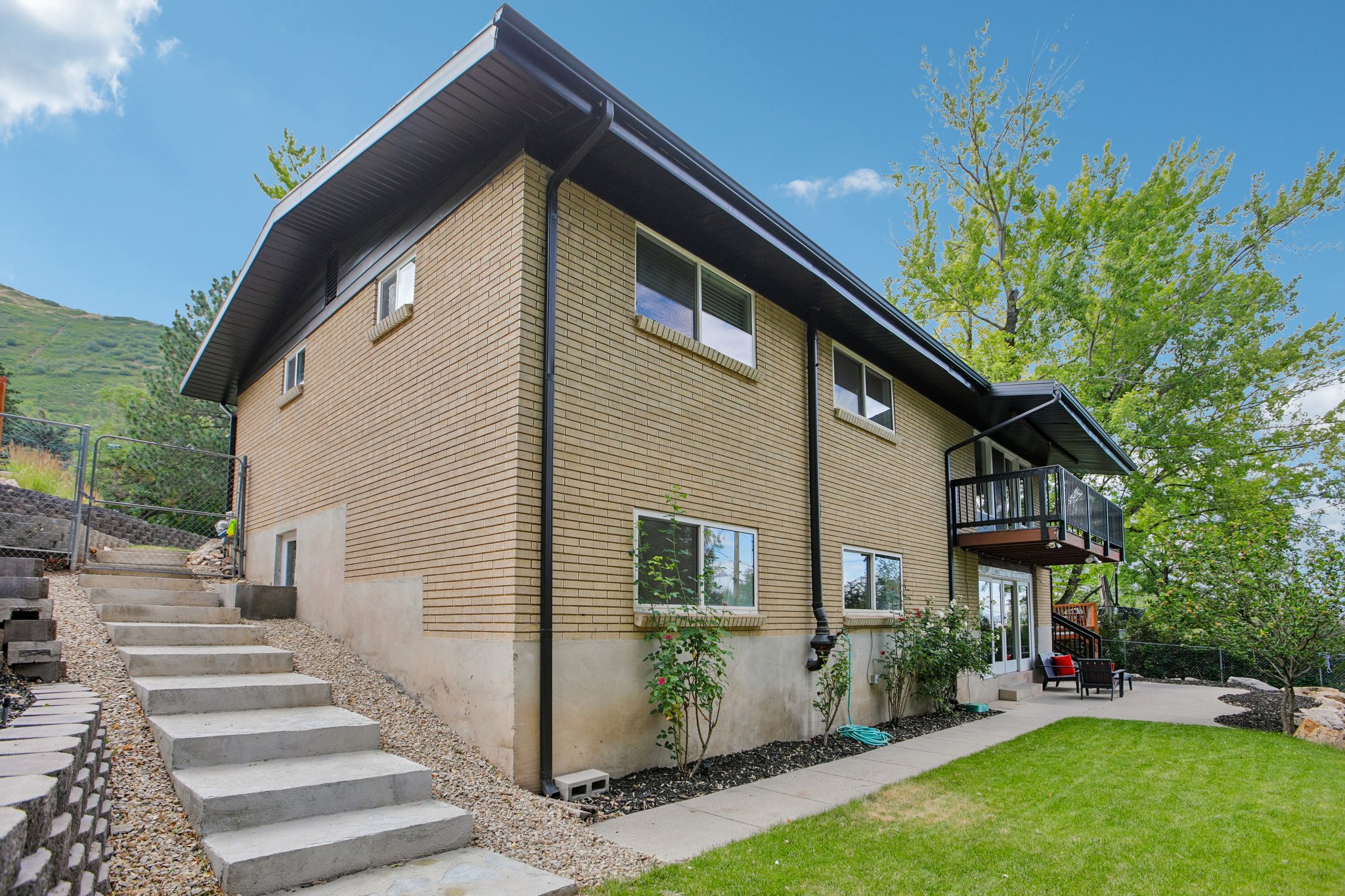 Brick exterior with dark trim and a multi-level design