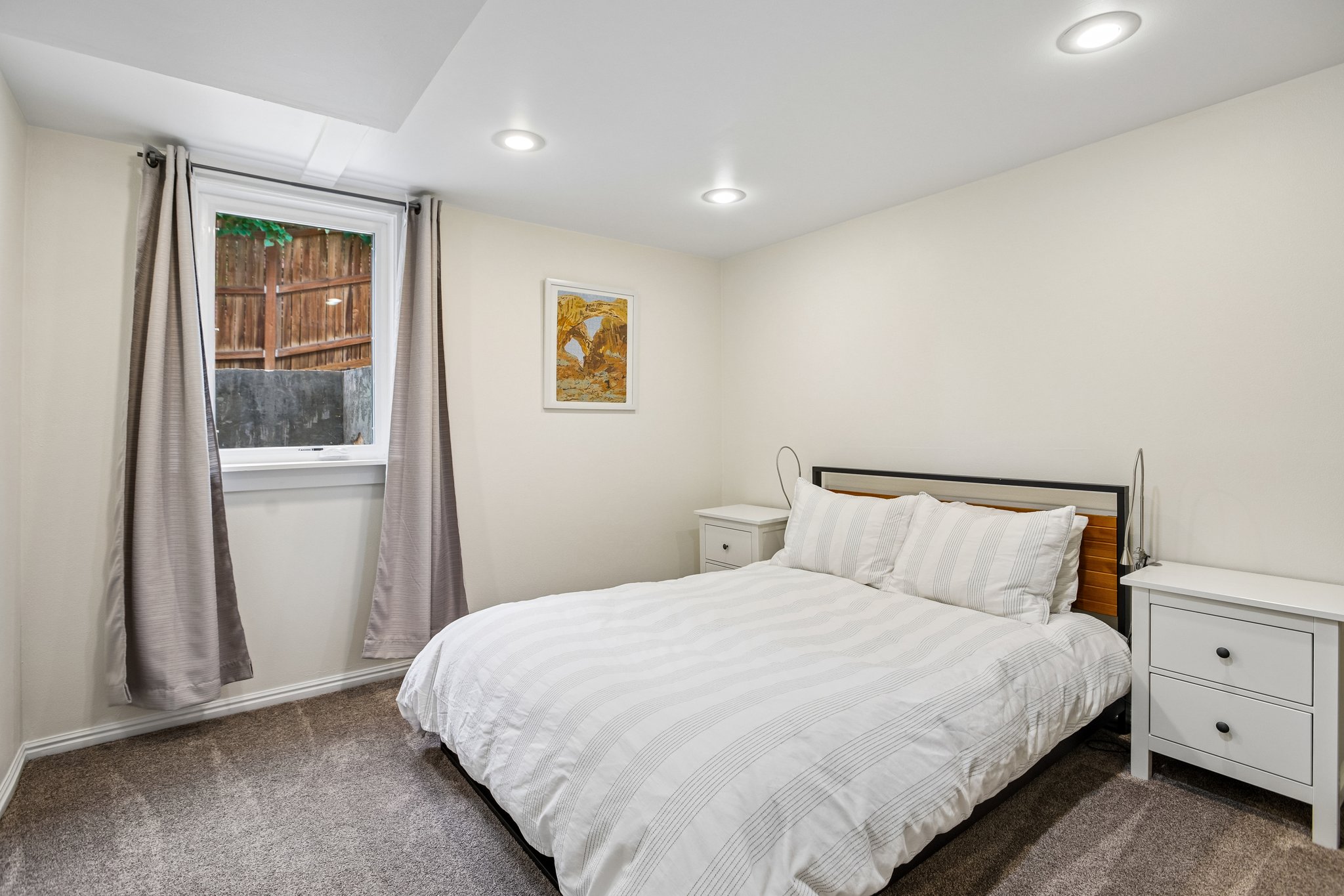 Windowed room featuring recessed lighting, a neutral color palette, and gray carpeting