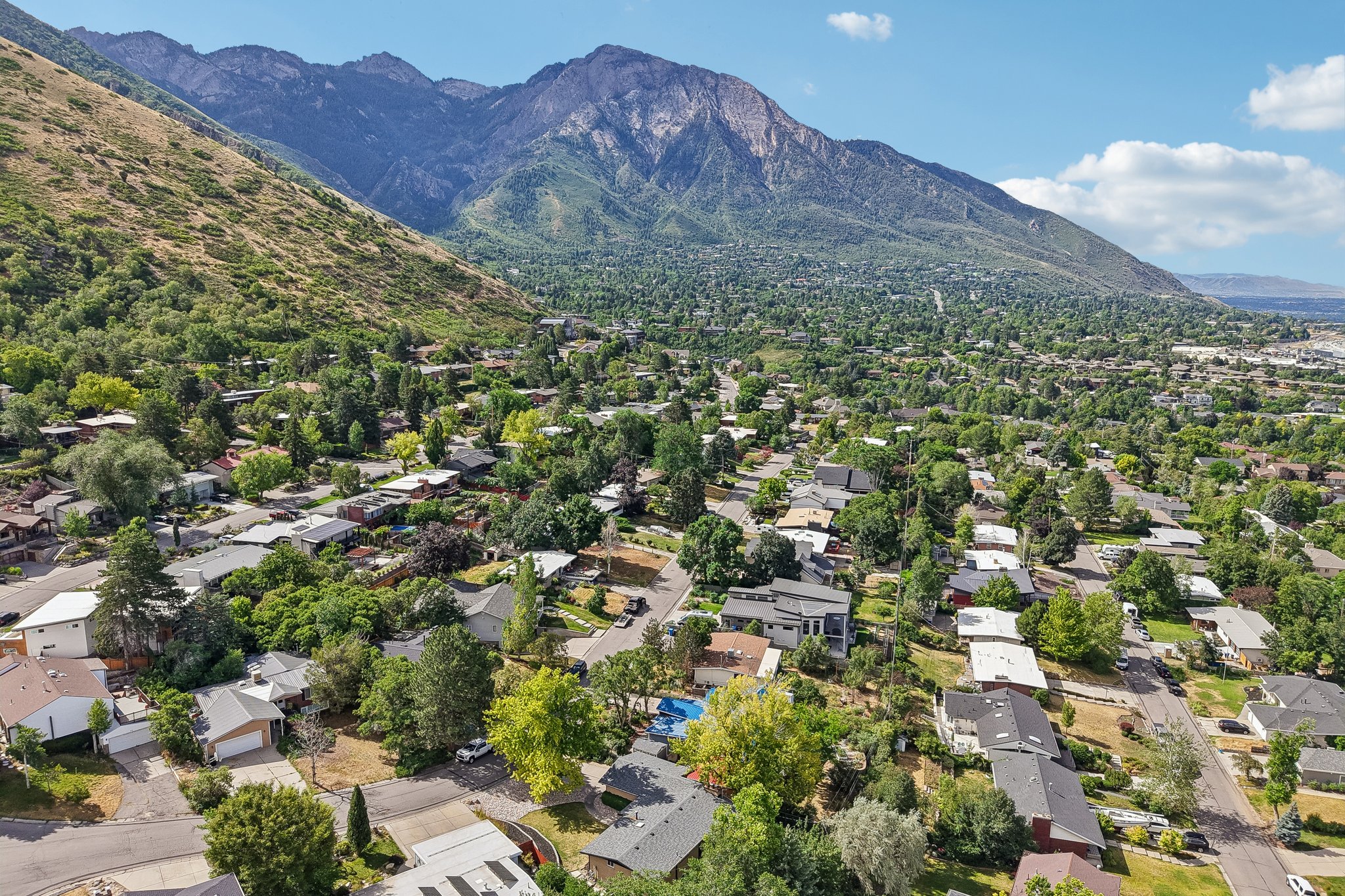Expansive residential area nestled at the base of a prominent mountain range