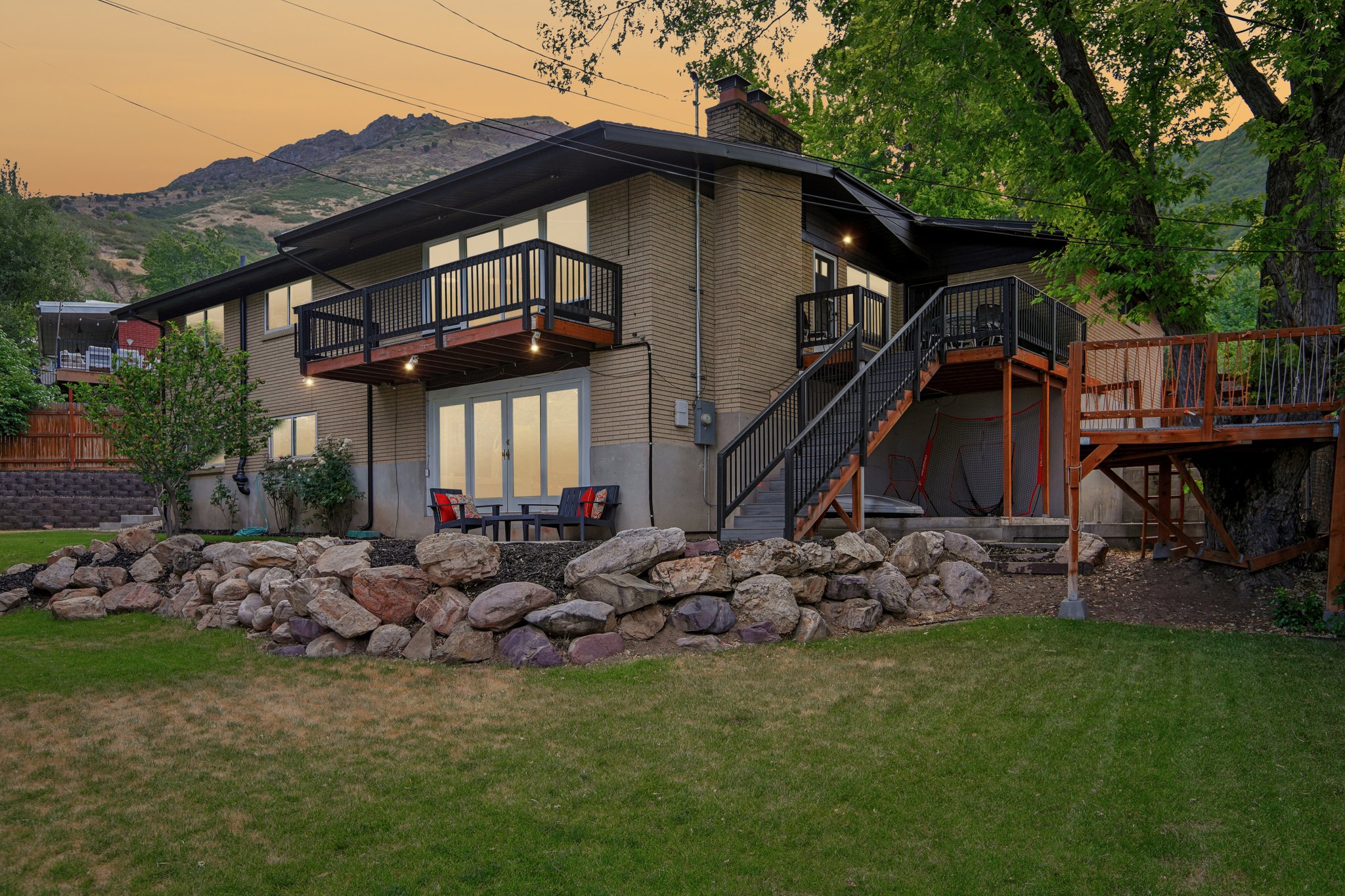 Brick exterior residence featuring multiple outdoor entertaining areas