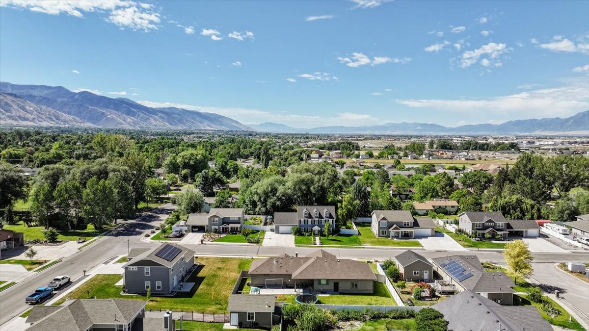 Residential neighborhood featuring a variety of single-family homes, mature trees, and paved streets