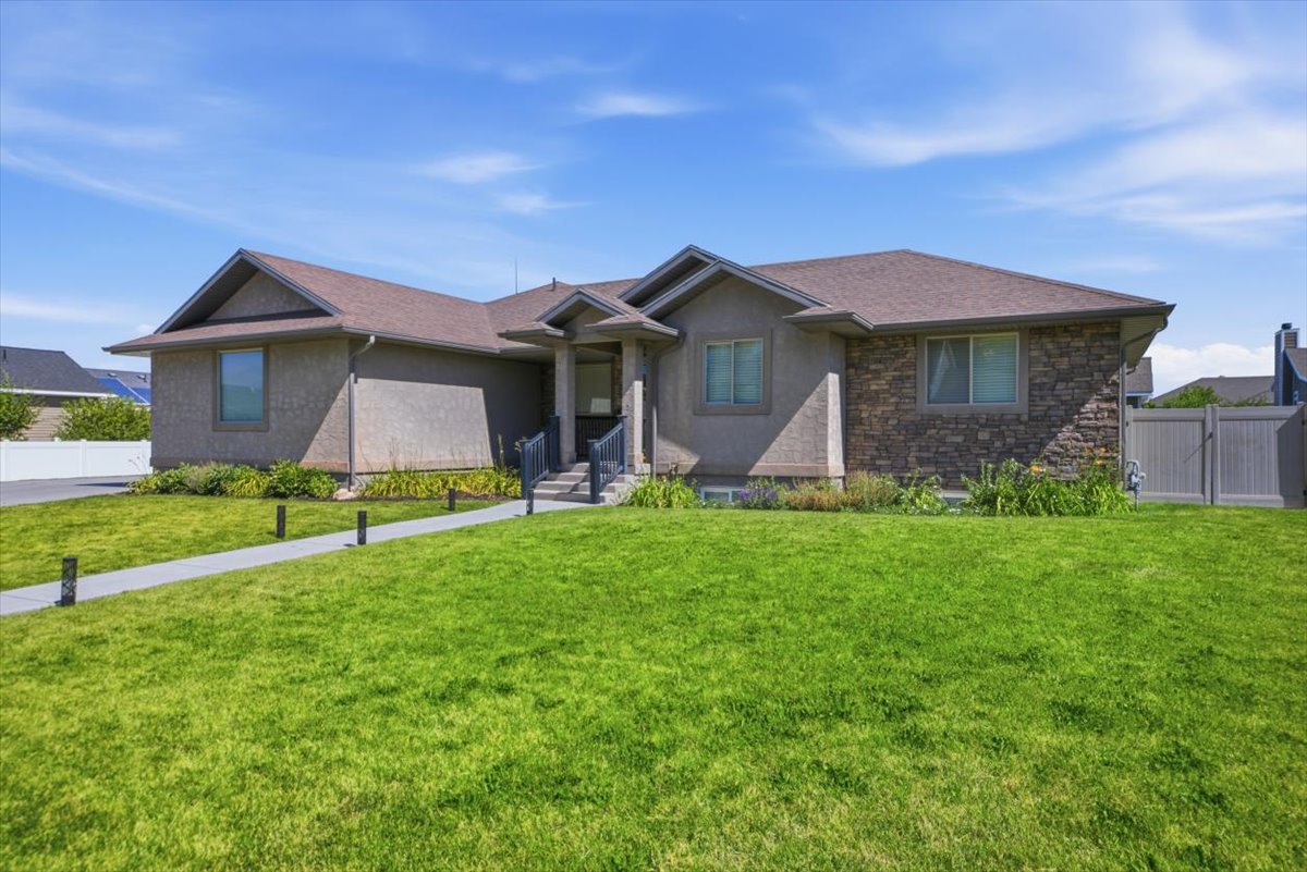 Single-story residence featuring a multi-textured facade with stone accents and stucco finishes