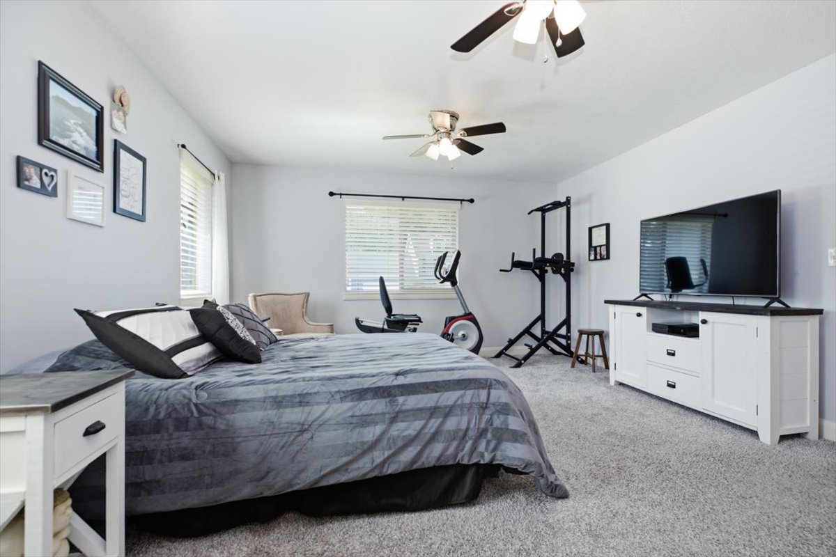 Spacious room featuring light-colored walls and soft carpet flooring