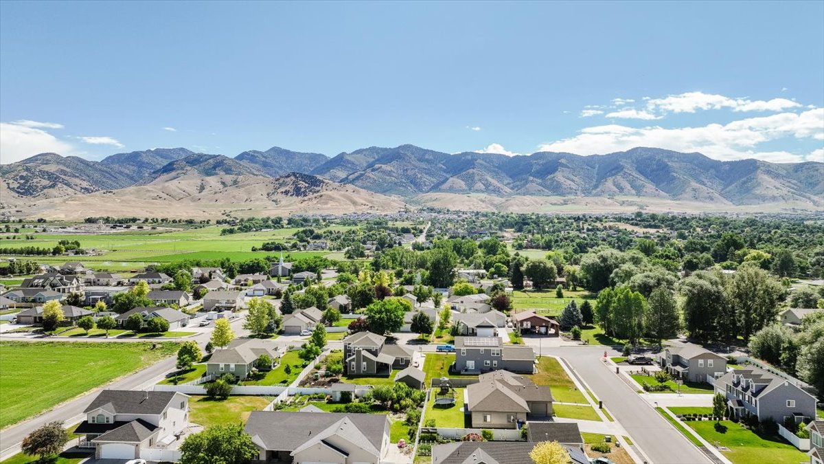 Expansive mountain range backdrop framing a residential community with varied architectural styles