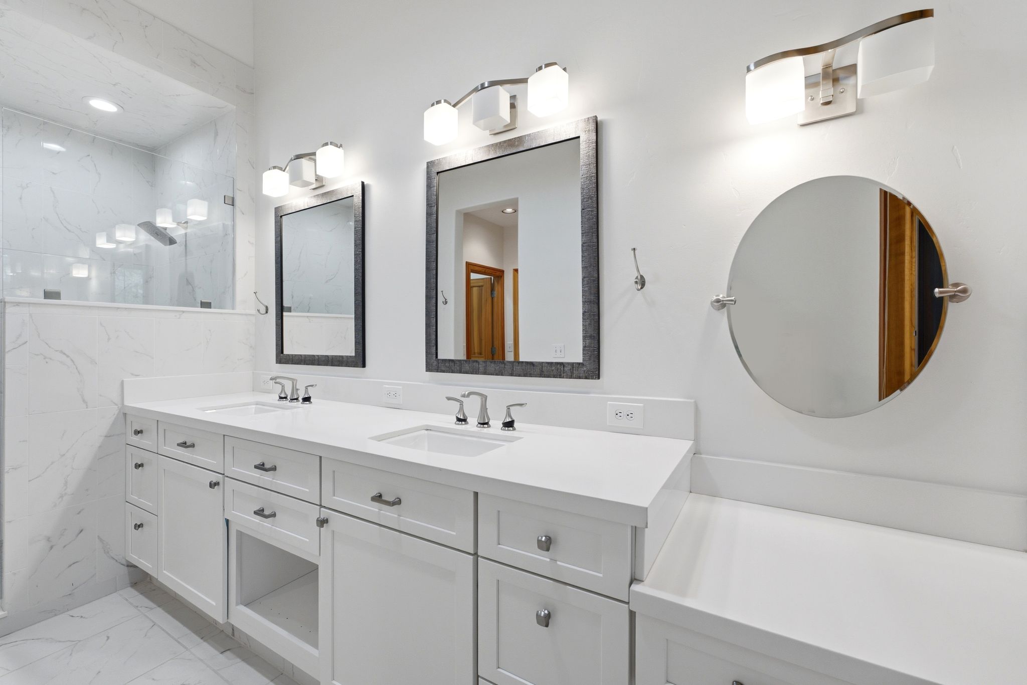 Double vanity with white cabinetry, integrated sinks, and polished chrome fixtures