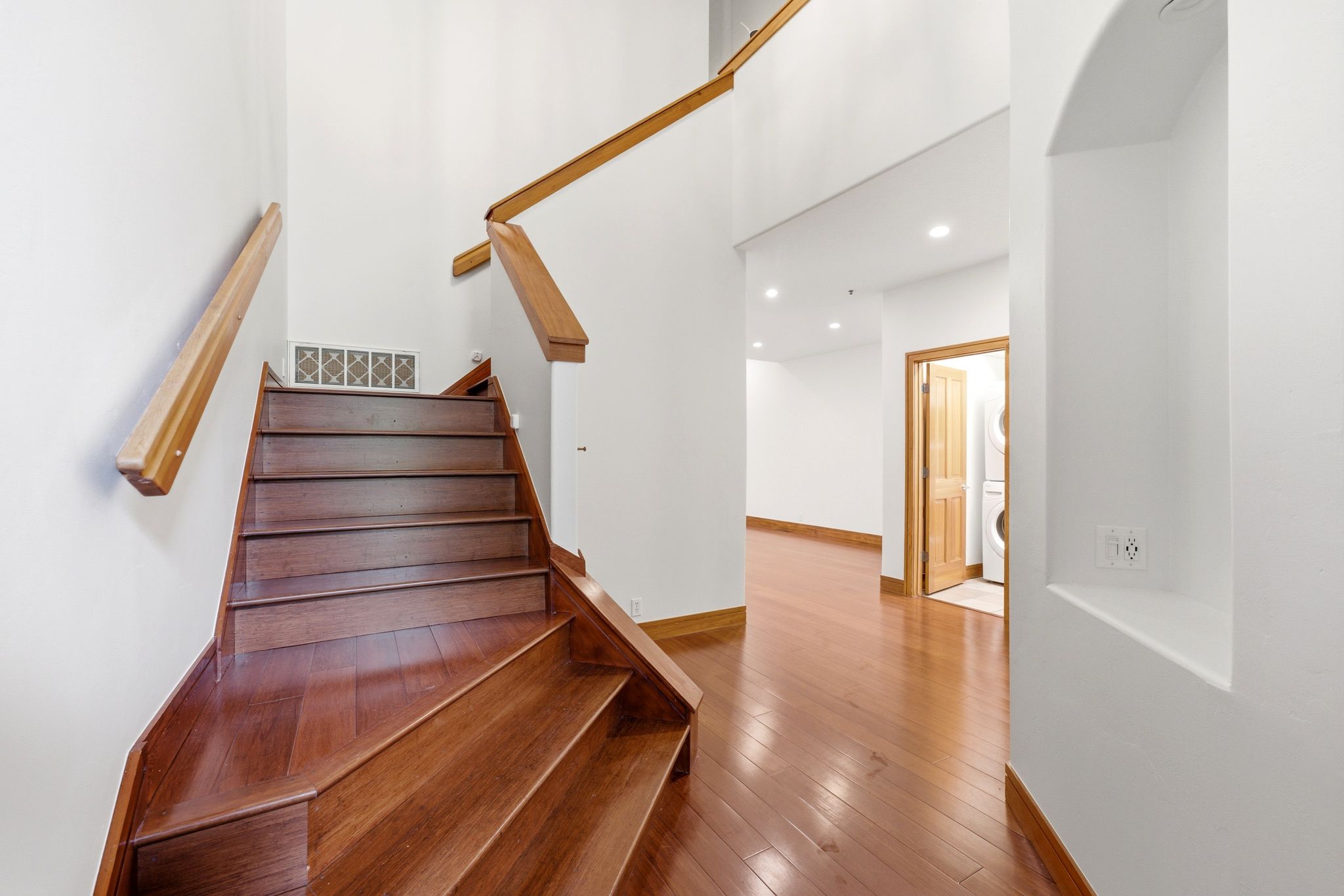 Hardwood staircase with natural wood handrails and risers