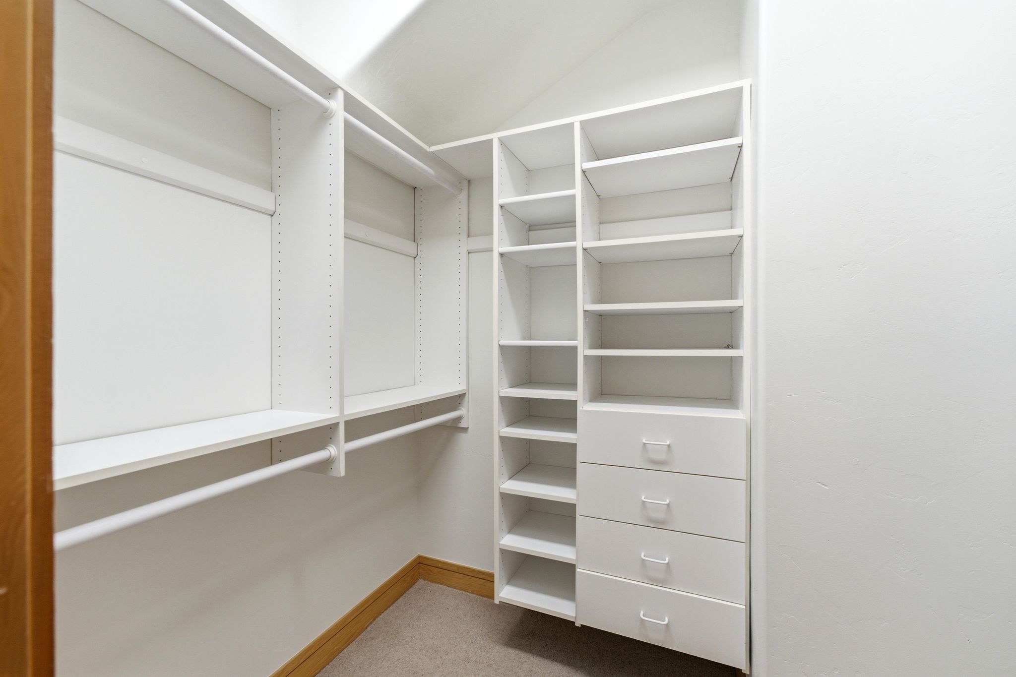 Custom closet system featuring white shelving and integrated drawers