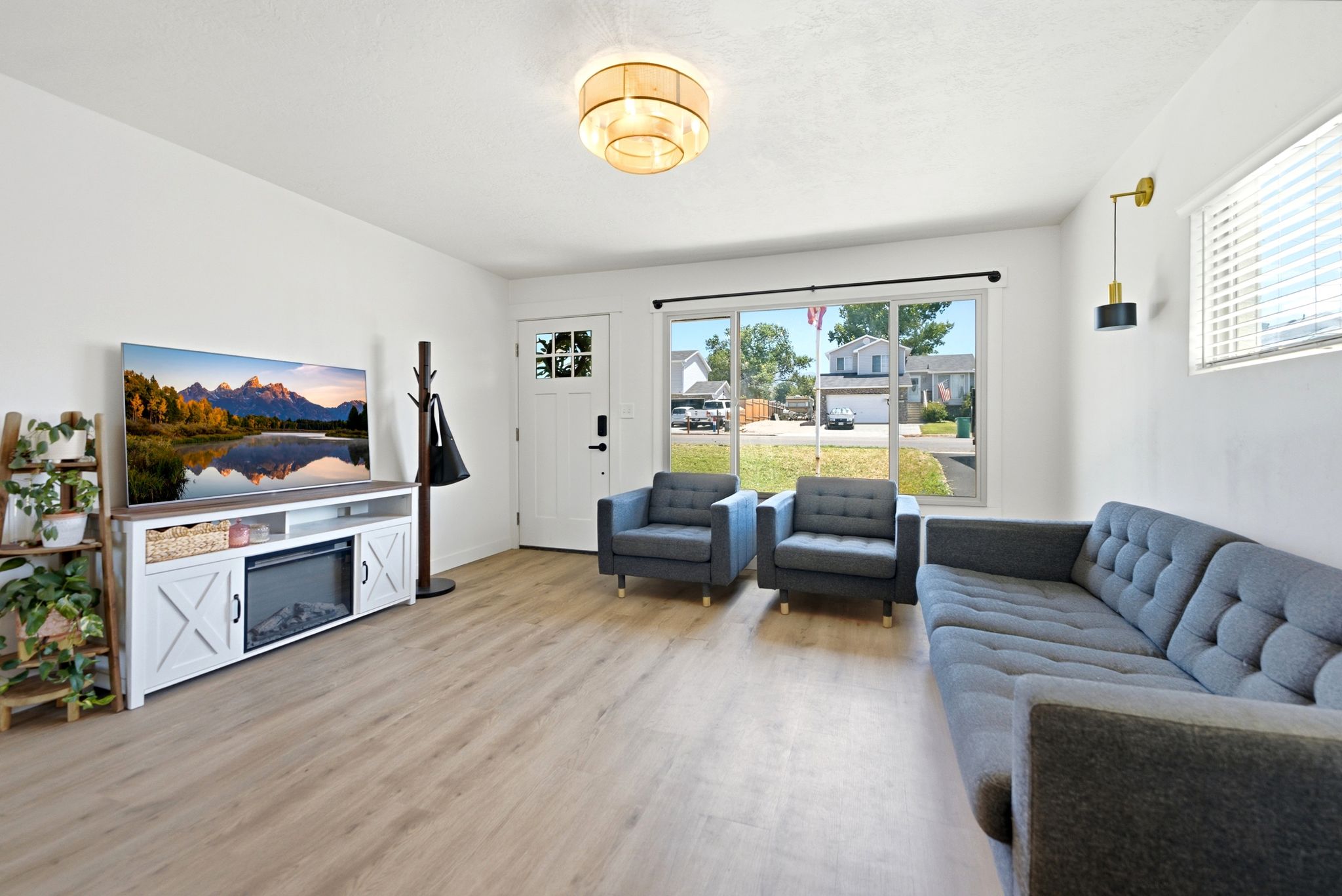 Bright living space featuring light wood-finish flooring