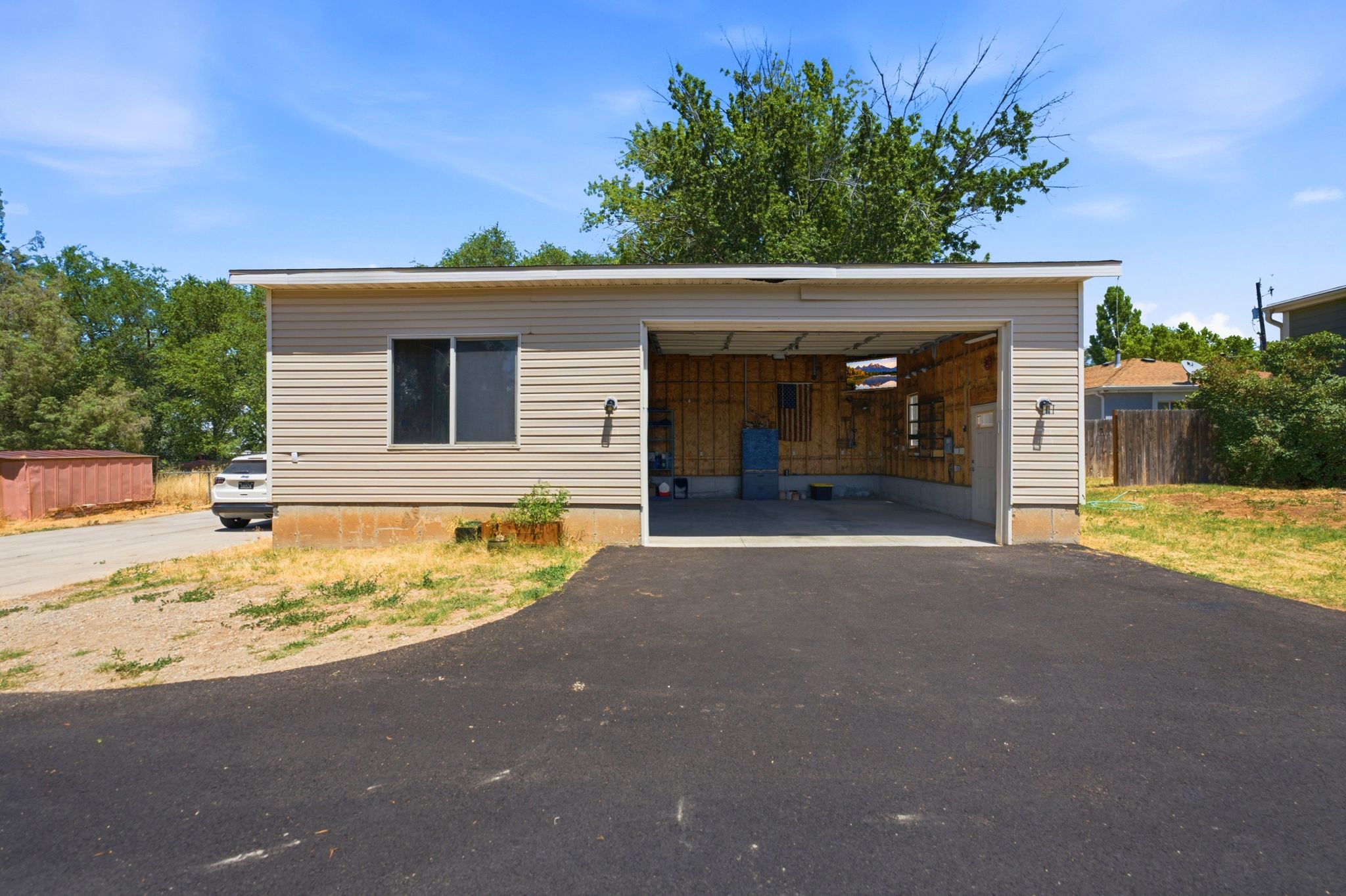 Detached outbuilding with light-toned horizontal siding and a flat roofline