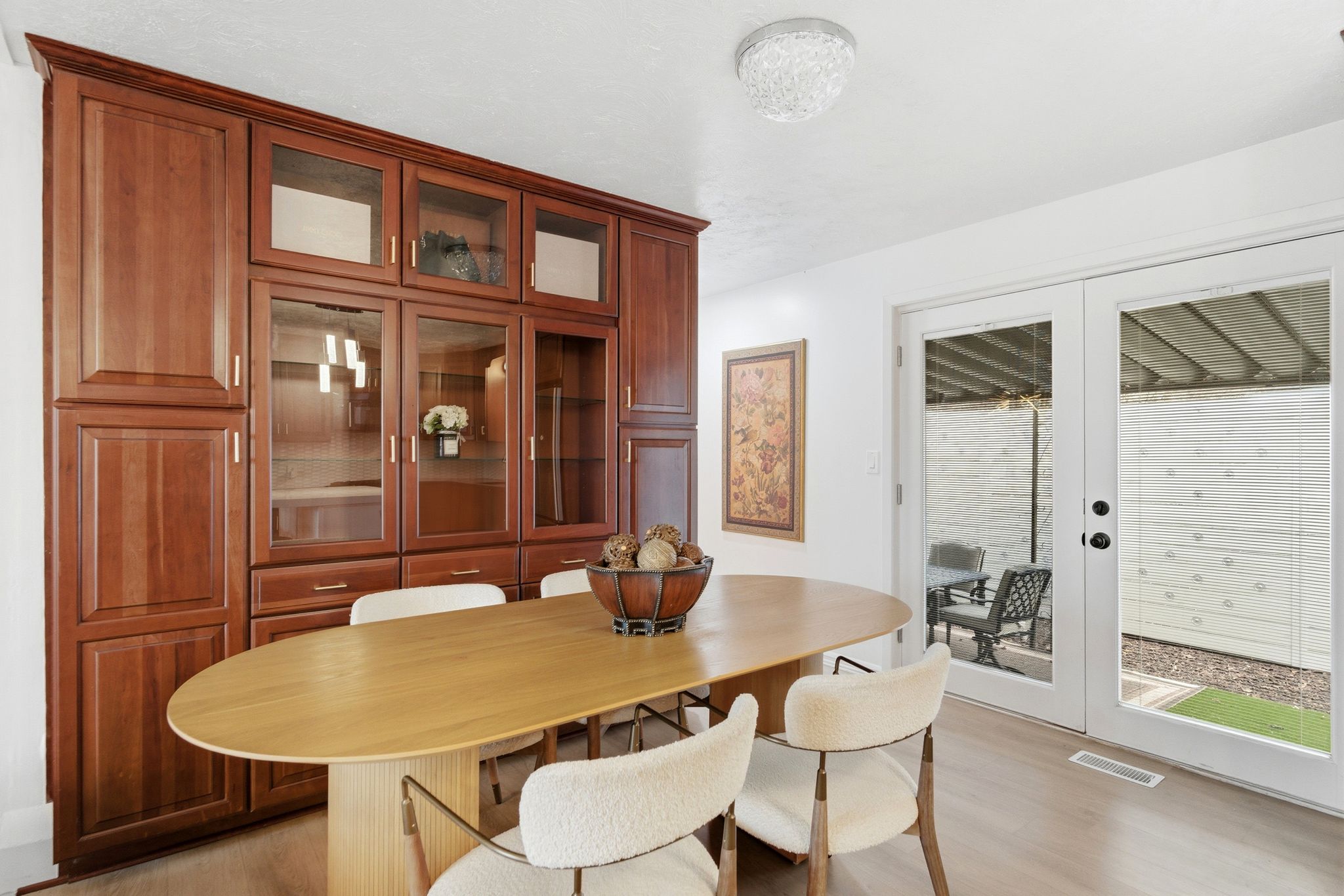 Floor-to-ceiling built-in cabinetry with glass-front display sections and wood-finish doors