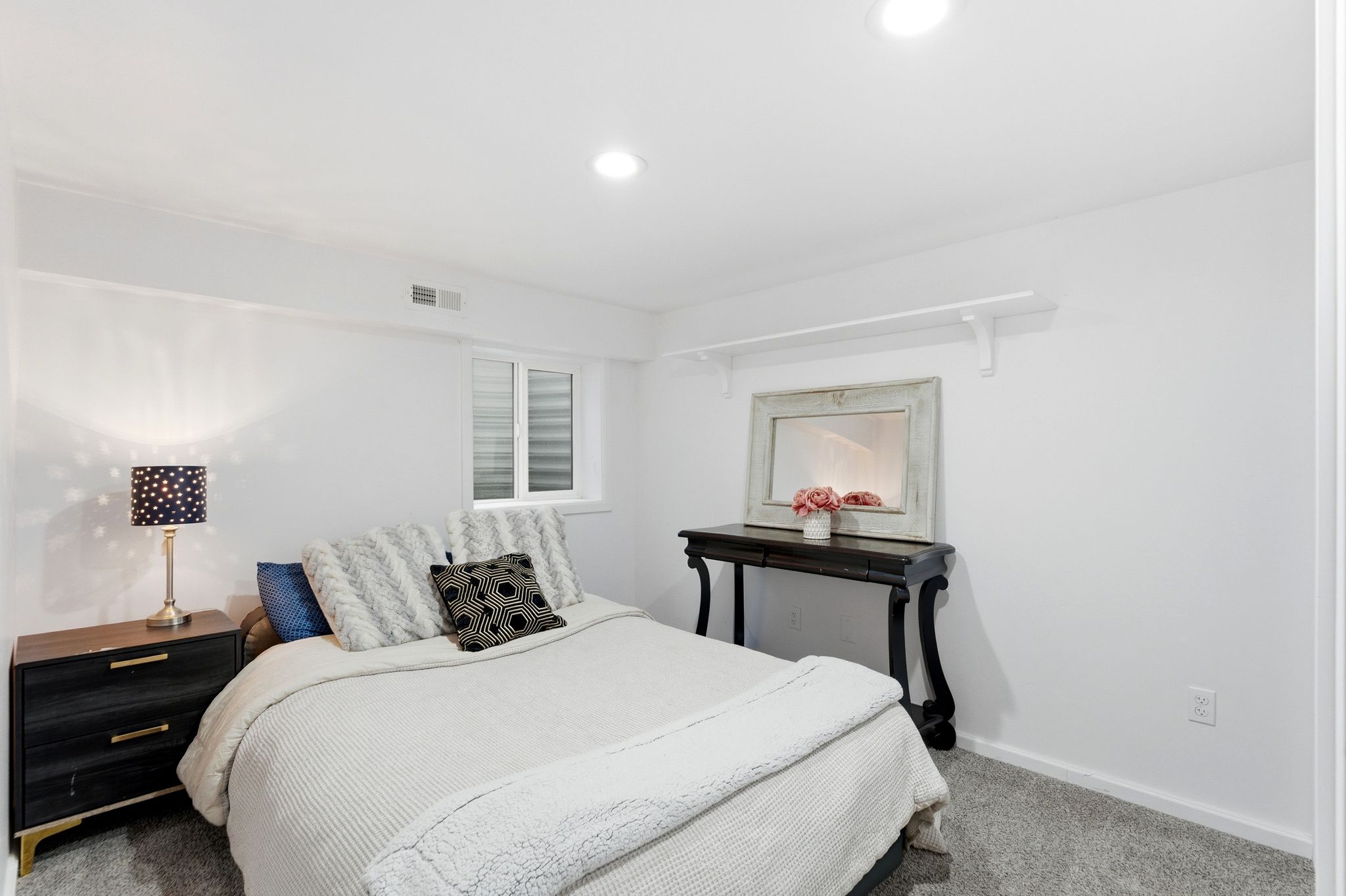 Carpeted room featuring recessed lighting and a window with horizontal blinds