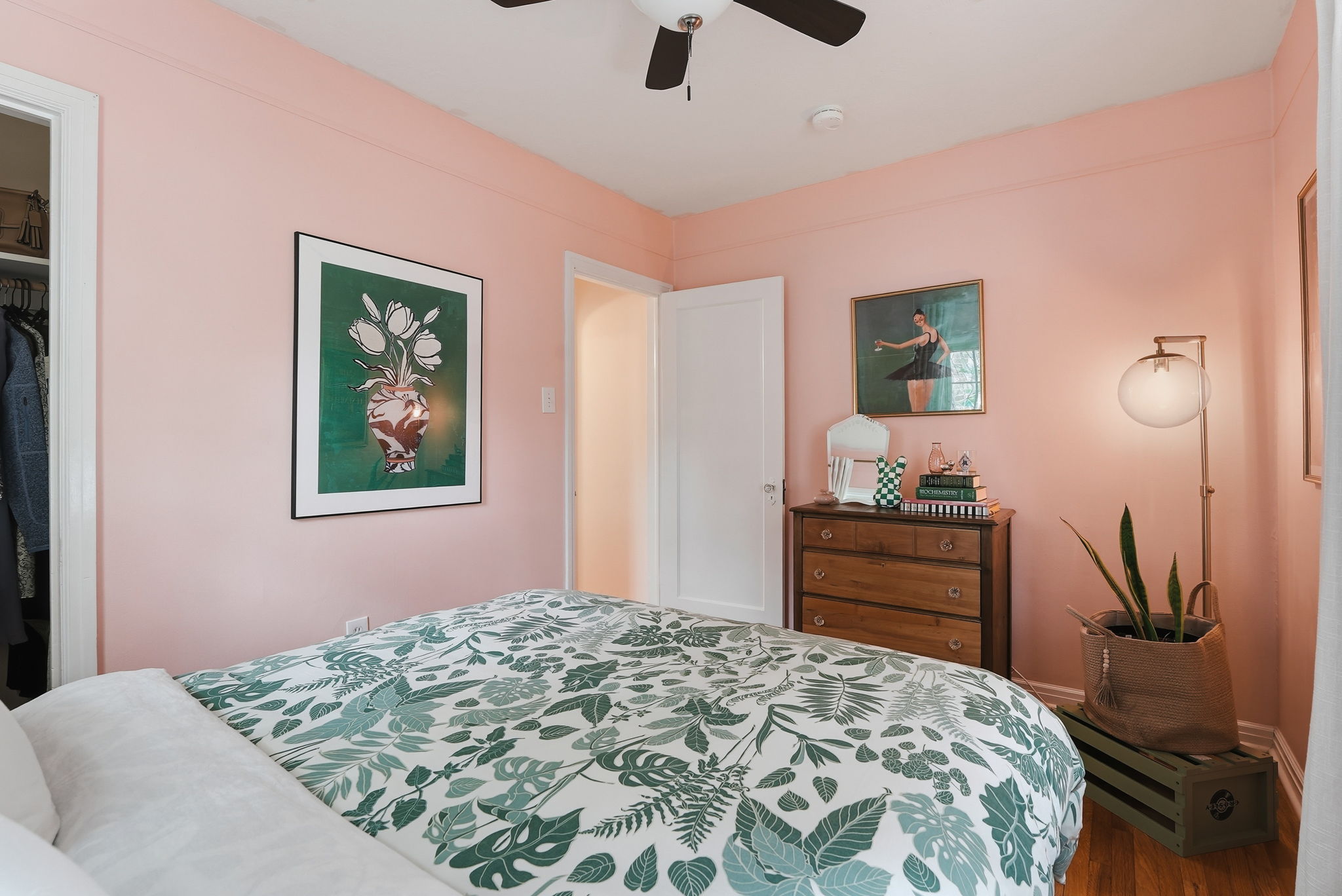 Interior space featuring wood-finish flooring, a ceiling fan, and a built-in closet with an interior light