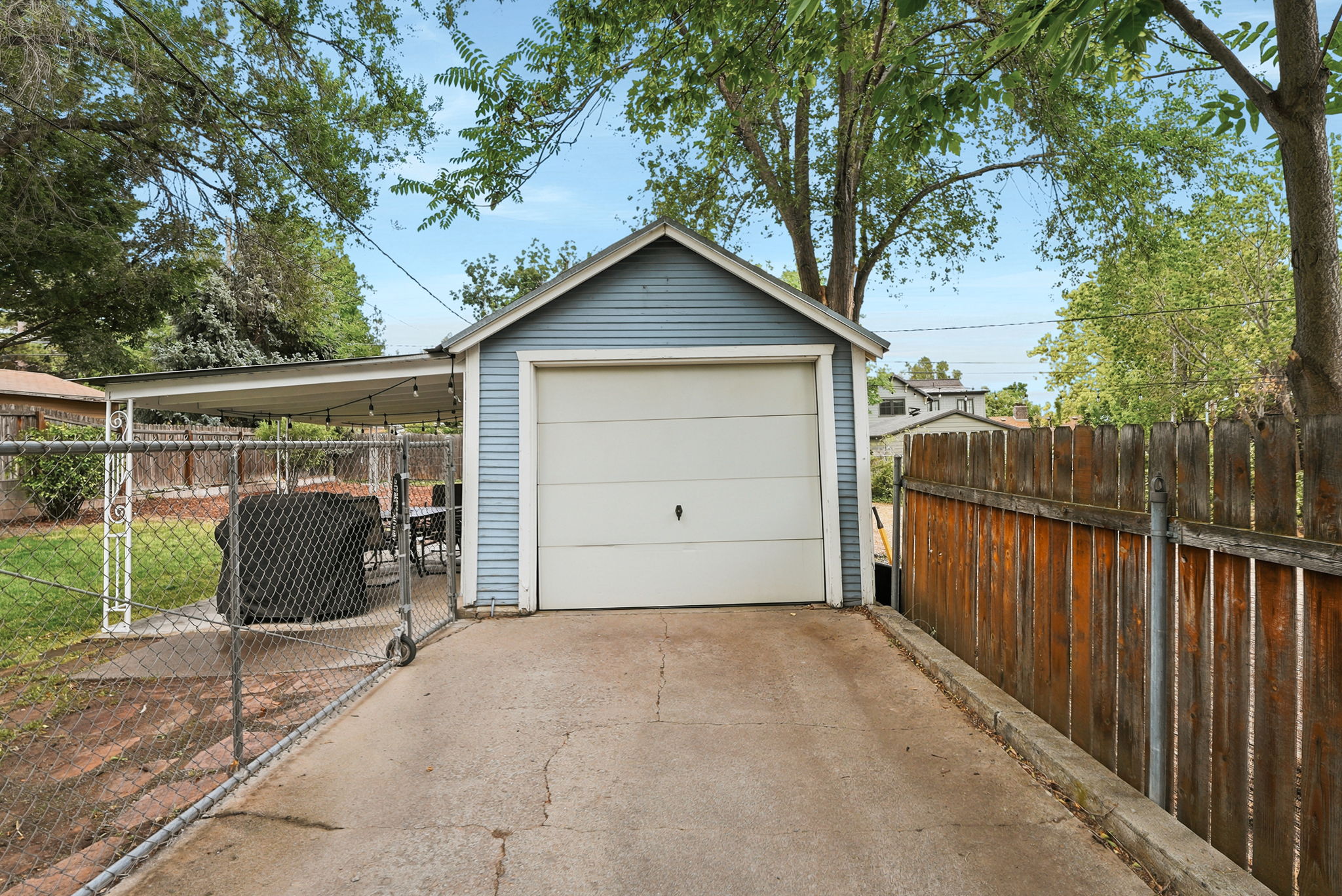 Detached garage with horizontal siding and a white sectional door